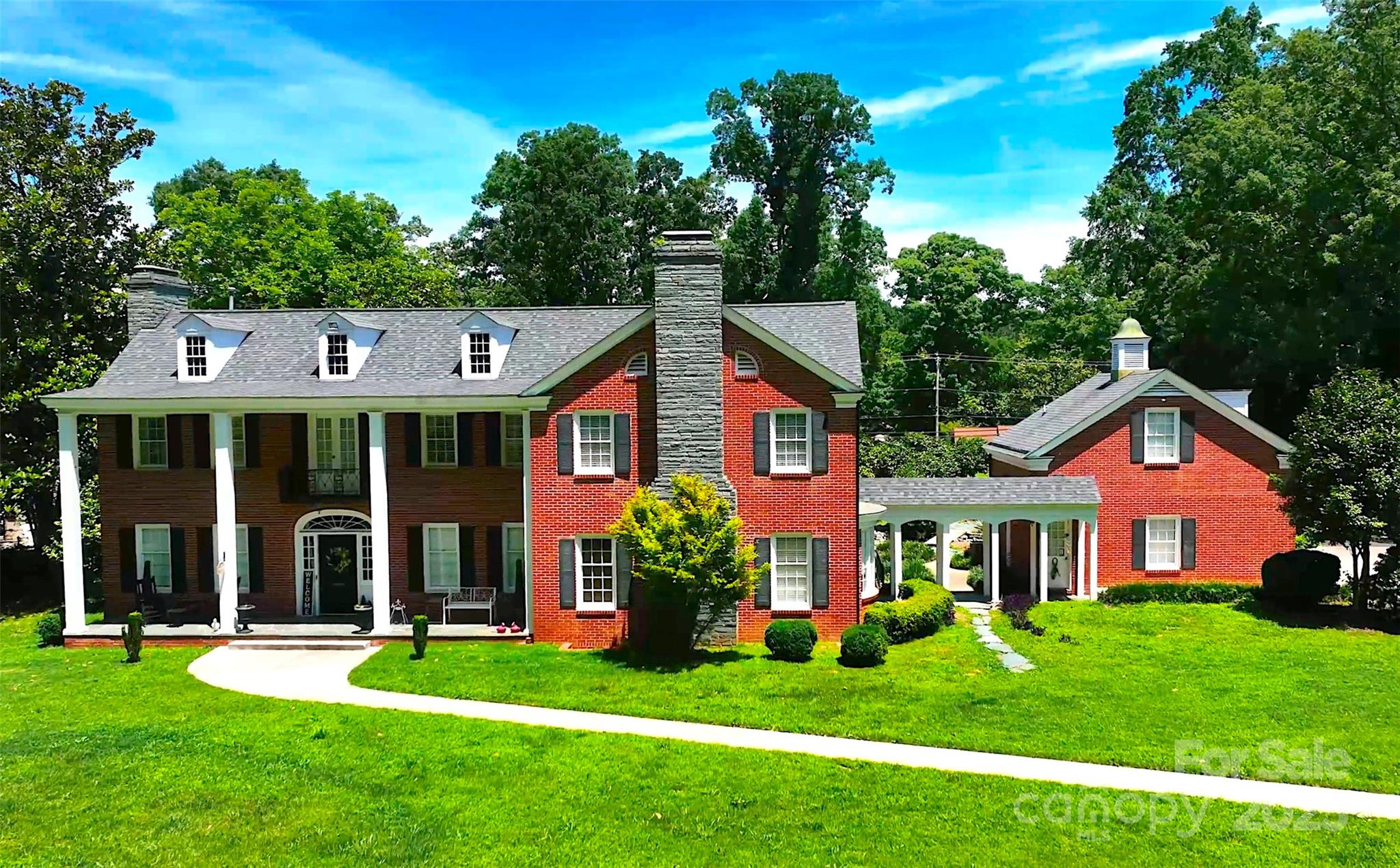 Delightfully well appointed & meticulously maintained Colonial-style Georgian home in the historic district of downtown Albemarle, NC - Built in 1950, fully renovated in 2003 & dramatically updated within the past few years, 1035 Pee Dee Ave offers over 5,200 finished square feet resting upon 1.84 +/- beautifully landscaped  acres. An 18’ x 36’ in ground swimming pool invites residents to relax among the tall, mature hardwoods, along the pool deck or under the spacious lanai. Access to an enormous attic area provides ample storage or build out opportunities. The home includes a 60/40 finished basement with home theater & wet bar, billiard and exercise rooms & workshop. A detached, full two-story apartment rests connected via breezeway and is perfect for family, guests or perhaps those on a short, local business stay. Furnishing & treatments negotiable
Fully paved driveway connects Pee Dee & Montgomery Avenues as the subject fronts both public streets