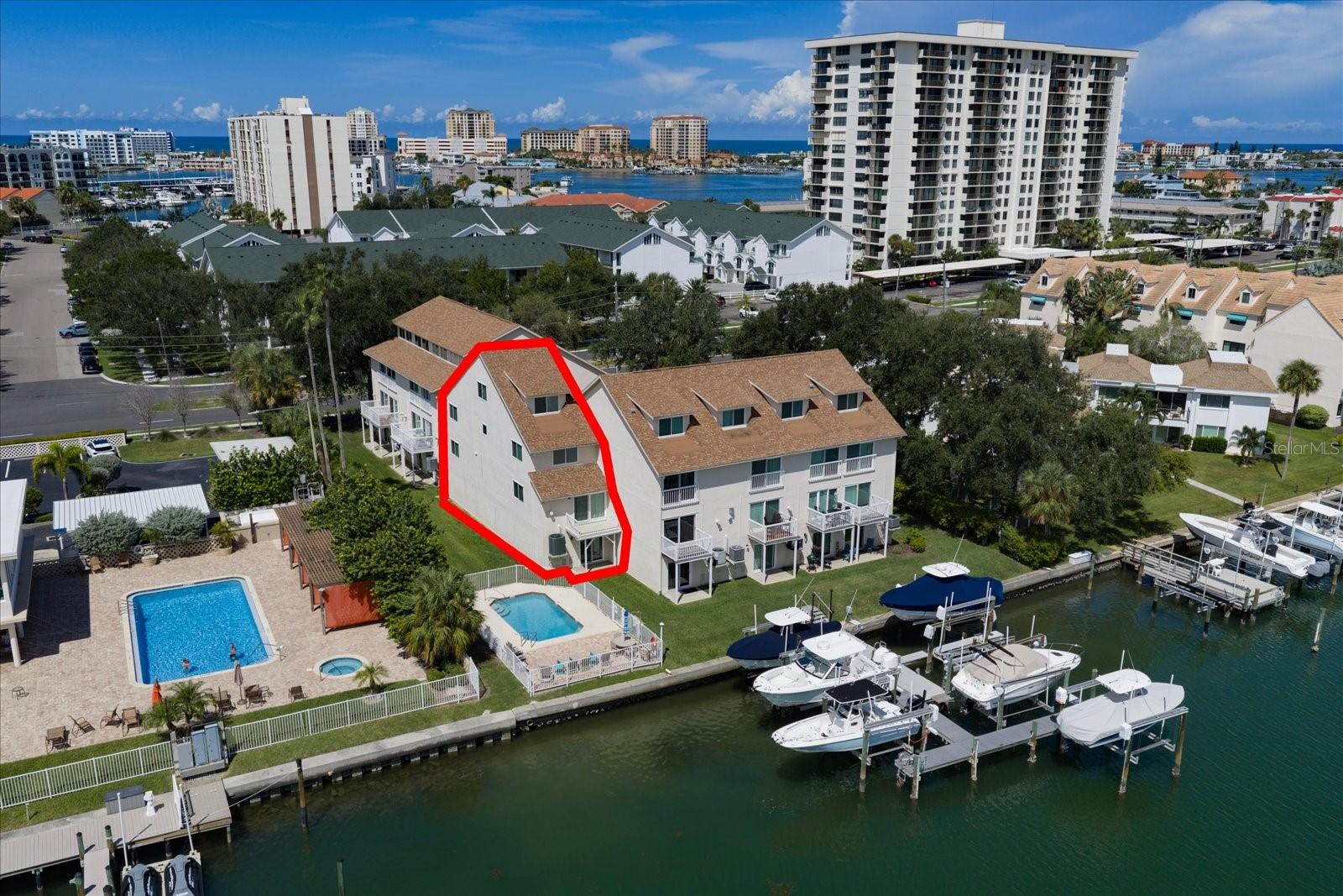 WATERFRONT TOWNHOME WITH PRIVATE BOAT DOCK & 12,000-LB LIFT ON ISLAND ESTATES! Enjoy the space, privacy and boating lifestyle of a waterfront home combined with the convenience of association-maintained living. Unlike many waterfront properties in the Clearwater Beach area, this residence is a townhome with an HOA—not a condominium—making it a unique opportunity on desirable Island Estates.This spacious multi-level corner residence offers approximately 2,200 square feet, 3 bedrooms, 3 baths plus a loft, with a private entry and added privacy from its corner location. Vaulted ceilings and an open floor plan create a light, spacious feel, complemented by an updated kitchen, renovated bathrooms and updated flooring. The oversized 2-car garage provides additional storage for bicycles, beach gear, paddleboards and all the toys that come with Florida waterfront living. Additional improvements include an updated garage door and new A/C in 2025.Step outside to your private dock and 12,000-lb boat lift and enjoy convenient access to Clearwater's surrounding waterways and the Gulf of Mexico. Whether heading out for a day of boating, fishing or simply relaxing along the waterfront, having your boat just outside your door is what the Florida lifestyle is all about.The $950 monthly HOA fee provides substantial value and includes water, gas, garbage, Spectrum cable and internet, exterior maintenance and association insurance, along with maintenance of the community swimming pool. Enjoy the comfort of waterfront homeownership while the association handles many of the exterior responsibilities—leaving more time for the things you moved to Florida to enjoy.Located on Island Estates, one of Clearwater's established waterfront communities, you'll find an exceptionally convenient island lifestyle with Publix, restaurants, shopping, banking, medical services and everyday conveniences right within the community. Walk, bike or take the Jolley Trolley to world-famous Clearwater Beach, with its sugar-white sand, waterfront restaurants, entertainment, Pier 60 and spectacular Gulf sunsets.Island Estates also provides convenient access to Clearwater Marine Aquarium, downtown Clearwater and the greater Tampa Bay area, with Tampa International and St. Pete-Clearwater International airports within easy reach. From boating and beaches to dining, biking and sunset cruises, this waterfront townhome offers the opportunity to enjoy the Clearwater Beach lifestyle every day—not just while you're on vacation.