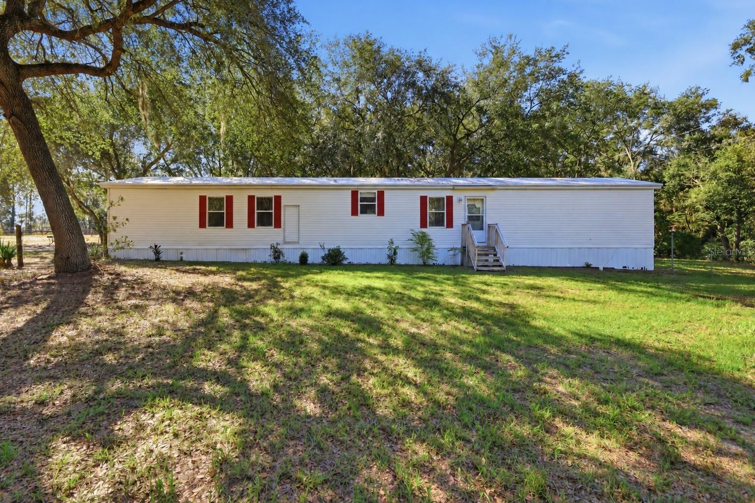 3.20 Acres of Space, Privacy & Possibilities!Looking for room to spread out and enjoy the outdoors? This 3-bedroom, 2-bath manufactured home, situated on 3.20 acres, offers a wonderful combination of comfortable living, outdoor space, and endless possibilities!A large portion of the property is fenced and thoughtfully divided into 3 spacious, separate fenced areas, offering flexibility for animals, hobbies, or simply enjoying your own piece of country living. The generous yard surrounding the home provides plenty of room for outdoor entertaining, gatherings, gardening, or relaxing while enjoying the peaceful surroundings. The separate fenced areas allow you to enjoy your outdoor living space while keeping animals in their own designated areas. Whether you envision horses, cows, chickens, or other animals, this property offers plenty of possibilities! *(Buyers should verify permitted animals and property uses with the county zoning department.)*Another great feature is the single horse stall with an attached feed and storage room, complete with electricity and water. The storage area provides plenty of space for hay, equipment, or other supplies.Inside, the home features a comfortable layout with plenty of natural light, upgraded recessed lighting, ceiling fans throughout, window blinds, new vinyl flooring throughout most of the home and a smart metored sprinkler system. The A/C system is 7 years old, well is 4 months old, and a septic drain field has new chambers.With no HOA, there's even more flexibility to enjoy the property and make it your own. Whether you're looking for space for animals, recreational vehicles, outdoor entertaining, gardening, or simply a little extra breathing room, this property offers an opportunity to enjoy country-style living with room to grow.Come explore the possibilities and imagine making this property your own!