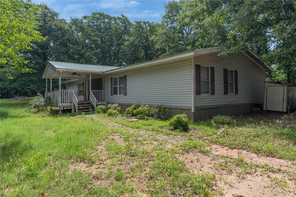 Offering the ultimate retreat with room to spread out, this expansive 4-bedroom, 3-bathroom manufactured home sits on 2 acres (MOL) of picturesque, tree-lined land just minutes from the shores of Lake Thunderbird. Designed for relaxed outdoor living and practical convenience, the property features a large carport to protect your vehicles or equipment, alongside two generous covered patios perfect for taking in the peaceful, heavily wooded views. Combining a prime East Norman location near lake recreation with the privacy of your own wooded acreage, this unique property offers incredible space and endless possibilities—reach out today to schedule your private tour!