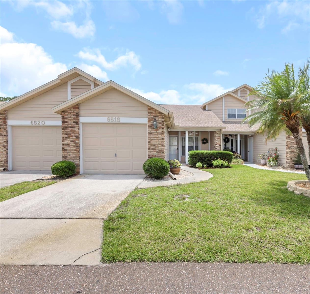 Welcome home to Briar Patch, one of New Port Richey’s most desirable and beautifully maintained 55+ communities. From the moment you enter this peaceful, secluded neighborhood, you’ll feel the charm and pride of ownership throughout. Perfectly positioned directly across from the community pool and clubhouse, this move-in ready 2-bedroom, 2-bath villa lives like a single-family home with an inviting front porch, attached garage, and private screened lanai for relaxing Florida living. Inside, you’ll find a spacious open-concept floor plan designed for both everyday comfort and effortless entertaining. The oversized kitchen features abundant counter space, ample cabinetry, stainless steel appliances, and flows seamlessly into the dining and living areas. The primary suite offers a large walk-in closet and an updated en-suite bath, while the split-bedroom layout provides privacy for guests with a second bedroom and full guest bath at the front of the home. This meticulously maintained villa includes numerous upgrades, including luxury vinyl flooring throughout. A/C (2019). Interior laundry with washer and dryer included adds convenience, while the attached garage offers additional storage space. Enjoy maintenance-free living with low HOA fees that include roof maintenance/replacement, lawn care, and trash service. NO CDD fees. Briar Patch residents enjoy planned social activities, beautifully landscaped grounds, and a prime location just minutes from shopping, dining, medical facilities, entertainment, Gulf beaches, Tampa International Airport, and downtown New Port Richey. Whether you’re searching for a seasonal retreat or full-time Florida lifestyle, this truly move-in ready home offers the perfect combination of comfort, convenience, and resort-style living. Schedule your private showing today, this exceptional Briar Patch villa won’t last long!