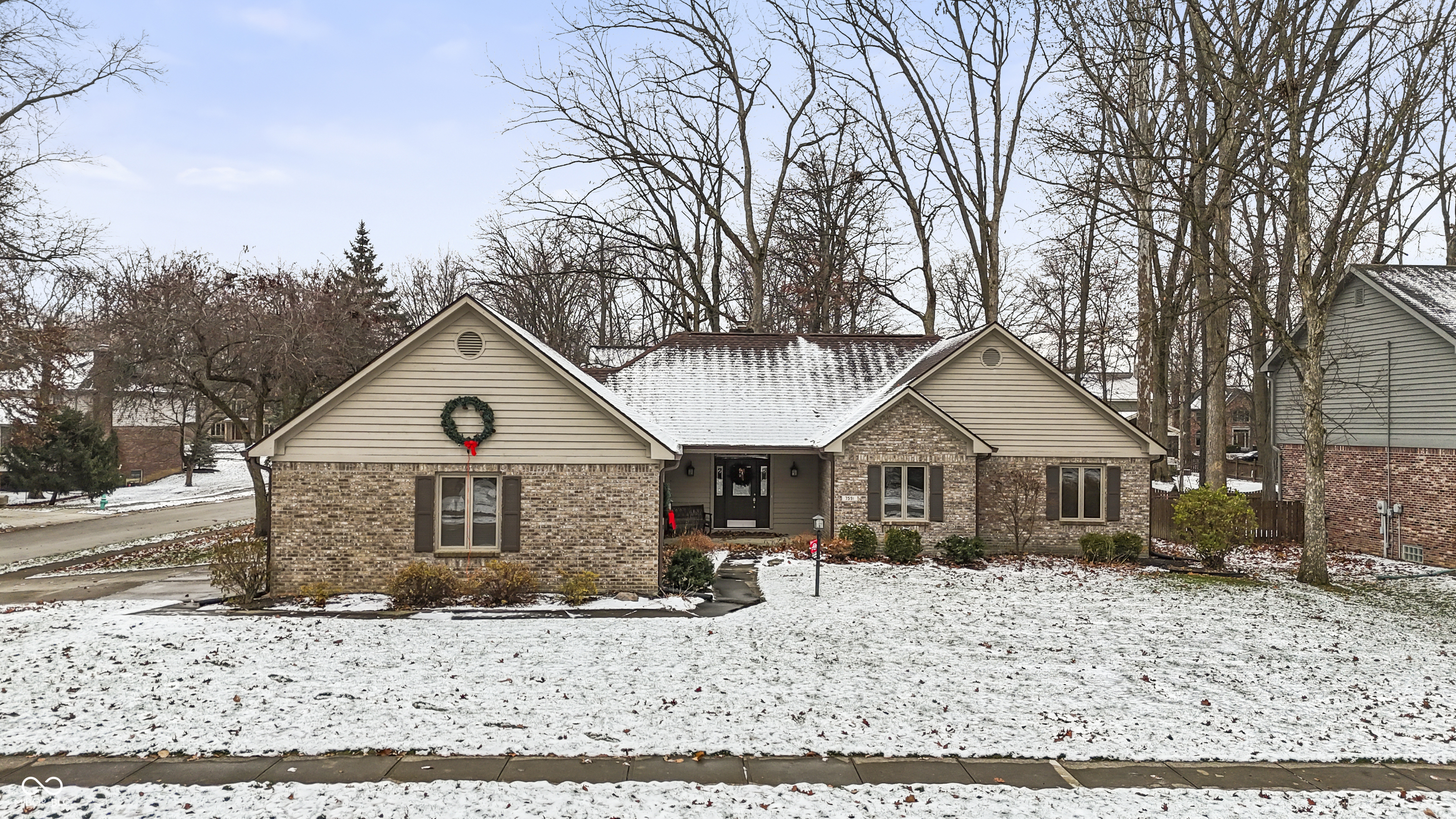 Tucked away at in a sought after Fishers neighborhood of Timber Springs this ranch style home on oversized corner lot with mature trees will charm its way into your heart. This home has been well cared for with many recent updates: New Roof, HVAC 3 years old, updated bathrooms, hardwood floors and much more.  The property features: 3 bedrooms, 2 1/2 bathrooms, finished basement with bar and side entry garage, deck of looking backyard.  The great room is an absolute showstopper, where laughter echoes and memories are made; imagine cozy evenings spent basking in the warm glow of the 2 story masonry fireplace, all while gazing up at the high, vaulted, and beamed ceilings, complete with elegant crown molding. It is a space designed to impress and built for comfort! The kitchen offers a culinary playground with its stunning granite countertops, stylish shaker cabinets, stainless steel appliances and a striking backsplash that adds a touch of pizzazz; the large kitchen island invite you to experiment with new recipes and host unforgettable gatherings, formal dining room or space could be used as flex space for your lifestyle. Retreat to the primary bedroom, where a tray ceiling adds an extra touch of architectural flair. The bathrooms offer a spa-like experience with their double vanity, a tile tub for luxurious soaks, and a walk in shower for a refreshing start to your day.  The expansive corner lot, provides ample space for outdoor activities, while the 2006 square feet living area offers plenty of room to spread out and relax.