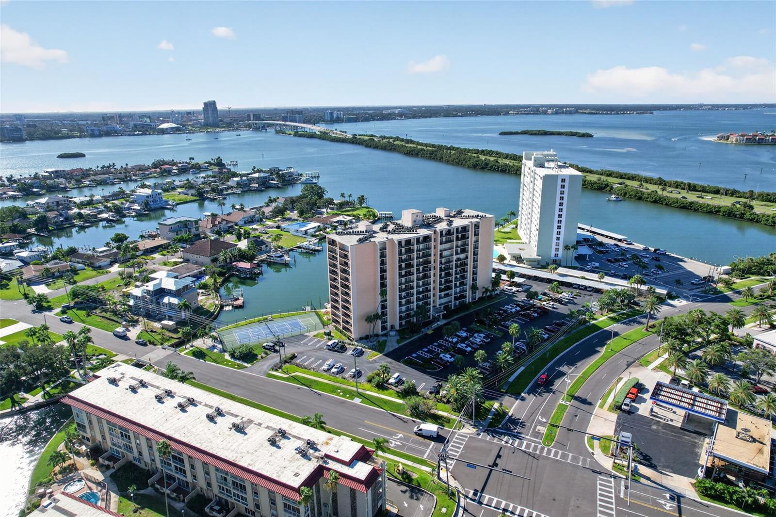 THE VIEW IS THE VALUE! Bring your contractor, your vision, and your design ideas to this desirable 11th-floor corner residence offering some truly spectacular panoramic waterfront views in Island Estates. With two separate balconies capturing sweeping views to the North, East and South, this 2-bedroom, 2-bath home offers an extraordinary opportunity to create a waterfront residence that is completely your own. Enjoy beautiful sunrises and sunsets throughout the year, sparkling water views from multiple vantage points, and an abundance of natural light that fills the residence.The spacious floor plan provides an excellent canvas for renovation. Rather than paying for someone else's finishes, bring your contractor and transform this home to reflect your own taste and lifestyle while taking full advantage of the incredible 11th-floor setting and breathtaking views.Enjoy resort-style waterfront amenities including a heated pool and spa, tiki bar, tennis, pickleball and shuffleboard courts, marina with boat slips available for approximately $60/month, kayak launch, saunas, BBQ areas, and inviting waterfront seating. Additional conveniences include optional covered parking, private storage, laundry facilities on every floor, secure keyless entry, and on-site management. The monthly fee includes cable, high-speed internet, water, sewer, trash, building insurance and reserves. Ideally located in sought-after Island Estates, just steps from Clearwater Marine Aquarium, Publix, restaurants and everyday conveniences, with easy access to Clearwater Beach, Pier 60 and the Jolley Trolley. Bring your contractor and your imagination—the interior can be transformed, but panoramic views like these simply cannot be recreated. This is your opportunity to design the waterfront home you've always wanted in one of Clearwater's most desirable island communities.
