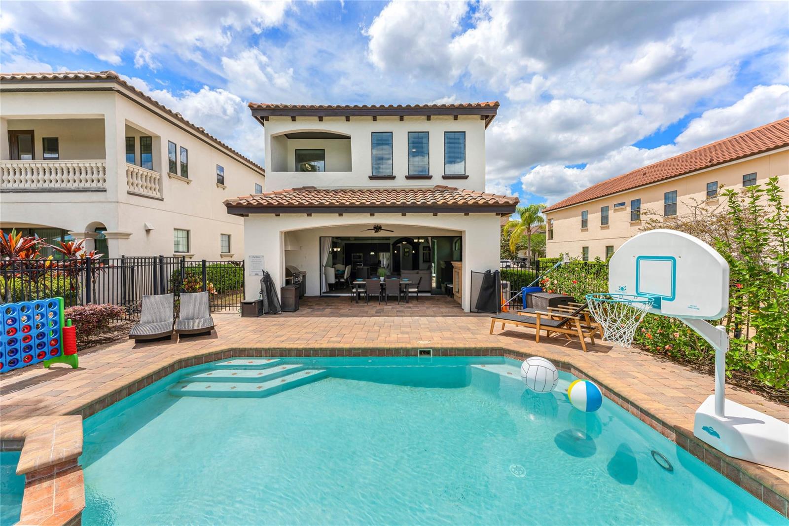 **ACTIVE REUNION RESORT MEMBERSHIP*** **Luxury, Lifestyle and Legacy is what Reunion Resort is all about!  Welcome to this 5-bedroom 4 bath CUSTOM home that is 3300 square feet with pristine GOLF COURSE views and nestled in the Highly Desirable Fairway Ridge Portion of Reunion Resort. Don’t settle for anything less than this spectacular custom-built home. You will not find this level of attention to detail and charm in any home of this size. EXTREMLY WELL MAINTAINED WITH NEW THEMED GARAGE MAKE OVER! The pool and outdoor space really stands out for style and size. Respectfully, the pictures do not tell the real story. The home has been energized with brand new paint inside and out. The Zen feeling in the home promotes a truly calm and tranquil feeling. When walking into the home your eyes are instantly drawn down the custom hallway into the large gathering space. The calm color palette is inviting and makes you start realizing there is something different about this home. The first-floor bedroom and that is hidden behind a secret hidden doorway. Once you discover the bedroom, you will want to see more of the home. The custom wood archway flows into a large open floor plan. Custom kitchen wood cabinetry, stainless steel appliances, granite countertops, and an island that should have its own zip code. Tons of seating for a quick bite or enjoying a glass of wine while a private chef entertains. Across from the kitchen behind a glass door there is a separate custom wine closet and storage area outfitted with a custom wine fridge. The living room is arranged with form and function in mind. A large comfortable sitting area with perfectly picked out furniture lets you know that not a detail was missed. The first-floor windows are also nicely accented with plantation shutters. After the inside of the property captures you, make your way outside through the oversized sliding glass door to the pool area. A covered lanai that is the width of the home shades you from the Florida rays. The pool and hot tub overlook the Nicklaus golf course and is the perfect place for some private swimming and lounging. The second floor is introduced to you by a wooden staircase and then you are greeted by a large loft area. The Master has a large walk-in closet and large master bath. There is also an oversized shower area. The back of the home also features a private master bedroom balcony which is the perfect escape for a early morning coffee. Reunion has it all! Three Signature Golf Courses- The Watson, The Palmer and The Nicklaus weave their way through the rolling landscape of the resort. The Tree lined streets make for great long walks or bike rides. Reunion boasts great dining options from a ROOF TOP TAPAS RESTURANT AND BAR, to THE CHOP HOUSE. Maybe its sushi in the lobby or a trip to a Reunion Hot Spot- THE NICKLAUS CLUBHOUSE. A Golf Cart Friendly community that is filled with activities for all, including Tennis, Putt-Putt, Pickle Ball, Member Events, Parties and a waterpark. If living or visiting Reunion, remember it is super close to theme-parks, shopping, and beaches. A Gated Community that works hard on staying the nicest in the area. This property is in a short-term rental program- which can really help it make sense when you not using it. The home will come fully furnished. Schedule a viewing today. It is in a STR program and does come with an ***ACTIVE REUNION RESORT MEMBERSHIP*** RENTAL INFORMATION AVAILABLE UPON REQUEST