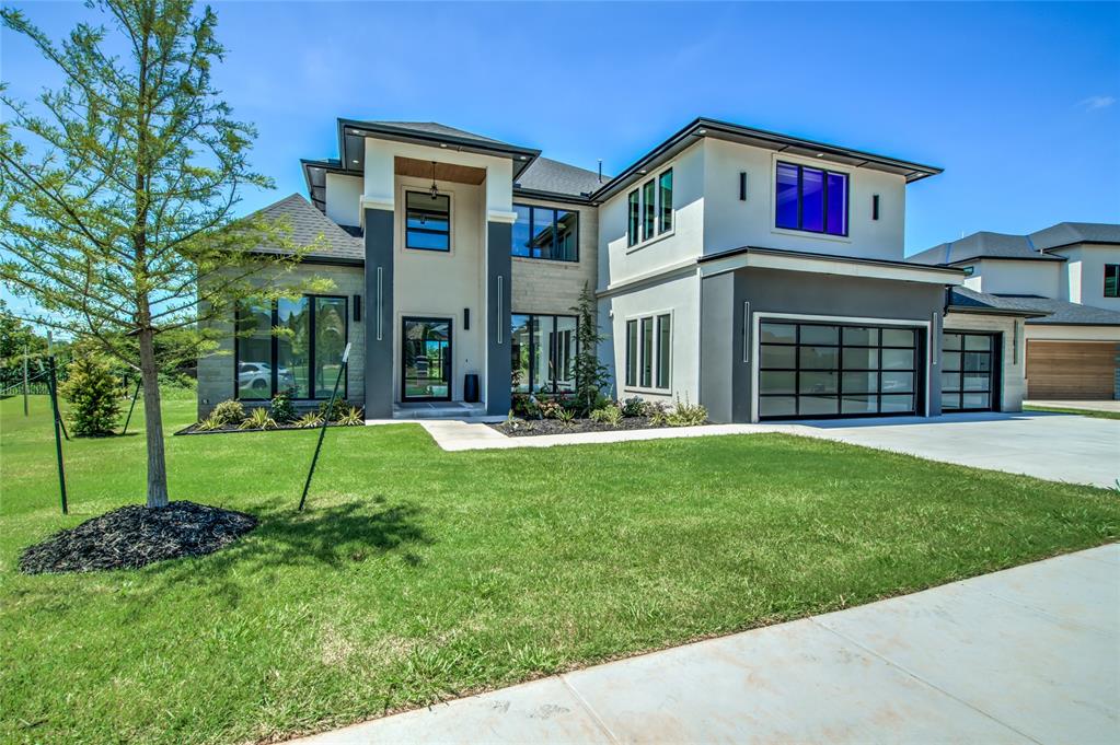 Waterfront property! Welcome to one of OKC’s most luxurious homes on the market! Just completed in a great location - hop on Kilpatrick Turnpike to OKC, Yukon or Piedmont all within 10 mins. Easy commute w hwy access. 30 mins to airport, 5 mins to Mercy hospital, restaurants and & shopping. Multi-generational floorplan w 2 PRIMARY SUITES on 1st floor each w spa bathrooms, walk-in showers & stand-alone tubs. Upstairs 3 more bedrooms w private bathrooms. Walk-out canopied balcony overlooking the lake is perfect spot for morning coffee or watching beautiful Oklahoma sunsets. Enjoy peace of mind w a concrete above ground safe room. 2 utility rooms, one for downstairs, one for up. Home offers a study, formal dining/living & bonus/media room w built-in bar. Open floorplan w 2 story ceilings & contemporary fireplace. Major WOW factor! Real hardwood floors throughout give this modern home a warm transitional feel perfect for any design style. Energy efficient quality-built construction includes wi-fi enabled sprinkler, full view glass garage doors & smart switches + 1yr Builder/10y structural warranty. The Grand is a private gated lakefront community offering peacefulness of country living yet located only minutes from downtown OKC. This master planned gated community is nestled around a fully stocked private lake, where homeowners can fish, paddle boar & canoe. The luxury style homes built in The Grand award winning and provide an elite lifestyle. Proud member of PIedmont school district w an outstanding reputation. Oklahoma City utilities & AT&T & Cox are available internet providers. Available for in-person or virtual tours.