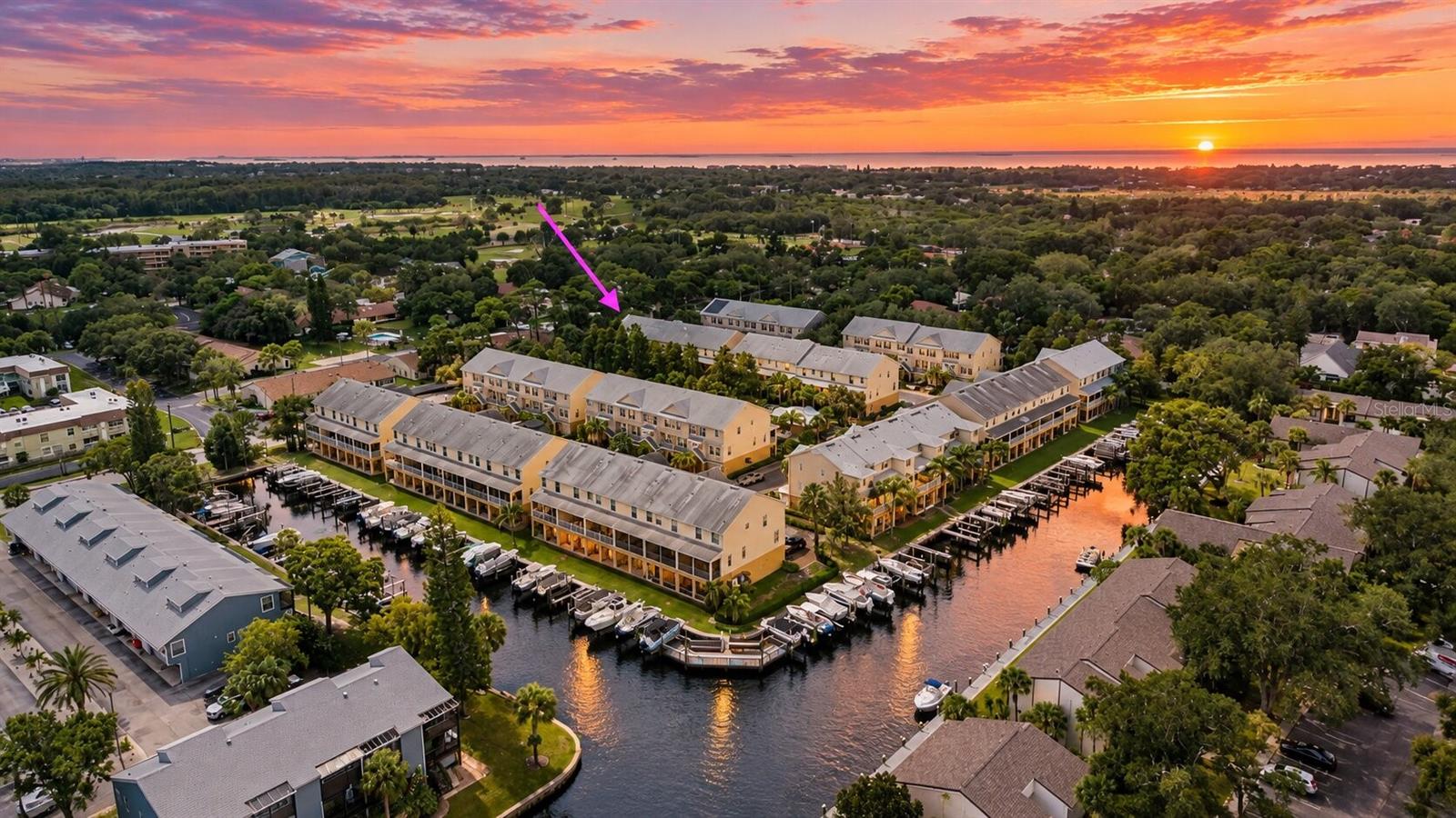 Welcome to Callista Cay, a beautiful GATED WATERFRONT COMMUNITY in the heart of Tarpon Springs, where boating, coastal charm, and everyday convenience come together! This spacious 3-bedroom, 2.5-bath End Unit townhome offers a thoughtfully designed three-level floor plan, exceptional upgrades, and an incredible opportunity to enjoy the Florida lifestyle. The first level features an OVERSIZED two-car tandem garage measuring approximately 19' x 41', and a large storage closet, offering abundant space for vehicles, golf carts, bicycles, kayaks, and all your Florida toys! There is even the potential to add a private elevator, providing additional flexibility for future needs. Upstairs, the main living level welcomes you with an open-concept design connecting the kitchen, dining, and family room, creating a comfortable space for everyday living and entertaining. Luxury vinyl flooring flows throughout the home, while hurricane impact windows and doors offer added peace of mind. Step outside to one of TWO beautiful screened outdoor living spaces, perfect for morning coffee, evening cocktails, or simply enjoying the surrounding tropical scenery. A convenient half bath completes this level. The third floor is dedicated to the bedrooms, including a generously sized primary suite with a beautifully updated bathroom and spacious walk-in closet. Two additional bedrooms, a full guest bathroom, and a dedicated laundry room on the SAME FLOOR make daily living that much easier. And then there's the lifestyle! Callista Cay offers residents the security of gated access along with fantastic waterfront amenities, including a COMMUNITY POOL AND HOT TUB, clubhouse with a kitchen and bathrooms, and a community dock. Love boating? Enjoy the opportunity for YEAR-ROUND BOATING, with boat slips often available for rent (average $275 a month), allowing you to take advantage of the surrounding waterways and Gulf Coast lifestyle. Beyond the gates, discover everything that makes Tarpon Springs so special! Explore the historic Sponge Docks, indulge in authentic Greek cuisine, stroll through charming downtown boutiques, enjoy waterfront dining, or spend your afternoons soaking up the sunshine at Fred Howard Park and Sunset Beach. The nearby Pinellas Trail offers miles of outdoor recreation, while the area's boating, fishing, kayaking, festivals, and beautiful coastal scenery make every day feel a little more like vacation. Whether you're looking for a full-time residence or the perfect seasonal coastal retreat, this home offers the space, thoughtful upgrades, community amenities, and LOCATION to enjoy the very best of Florida living.  HOA covers Water, Sewer, Trash, Basic Cable TV, Internet, Maintenance of Grounds, Community Pool, Painting of Exteriors, Roofs, Roads and Gates for $430 a month. Assumable flood policy available for $610 a year.