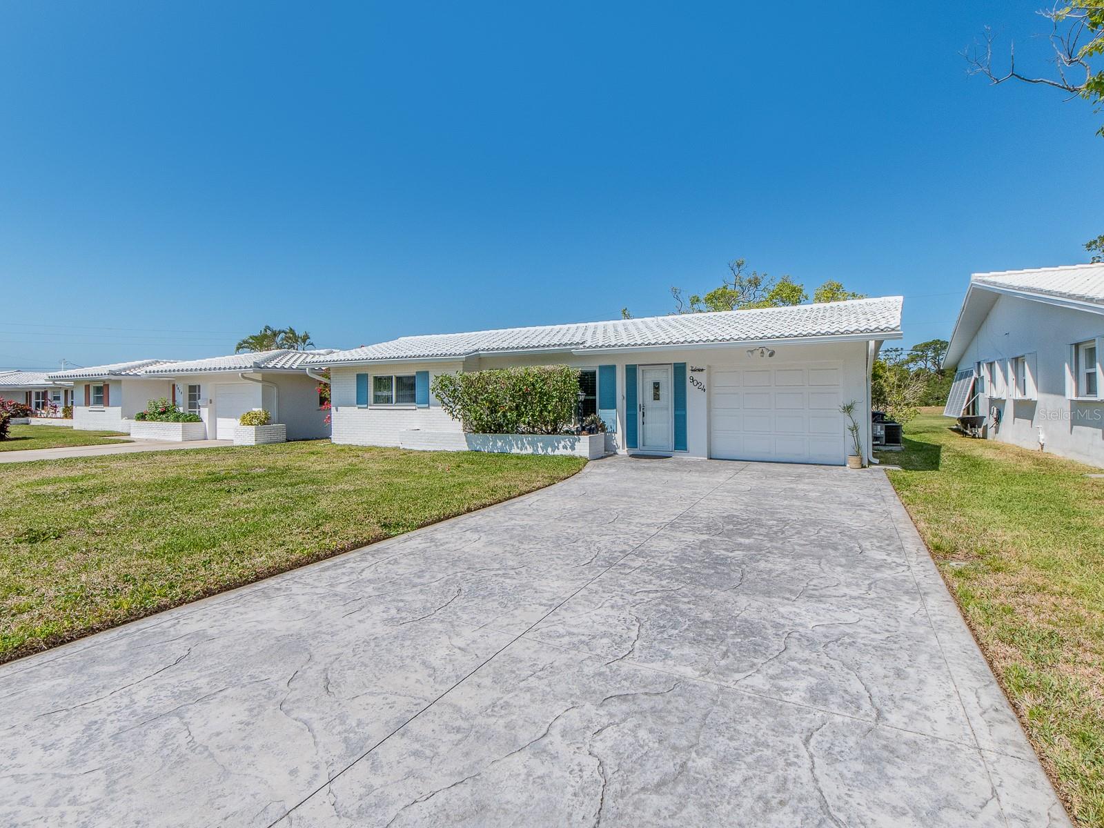 This home has it ALL!  No backyard neighbors just the beautiful Baypointe Conservation Area.  The ROOF is less than a year old.  The WINDOWS are impact.  There a wonderful flow to this home.  The kitchen has beautiful Shaker cabinets, granite counter tops and stainless appliances.  The laundry room off the lanai has custom cabinets and can easily be put under air.  There's an ocean breeze all year round and the lanai is the perfect place to enjoy it.  The driveway has been widened to accomodate two + vehicles. There's very easy access to the 2 mile walking trail on the Conservation.  Tamarac is a QUIET, 55+ beautifully maintained neighborhood with Clubhouse and heated pool.  The activities calendar is full.  The HOA fee of $230.24 a month covers sewer, water, trash, yard maintenance, cleaning of roof and painting of the home.