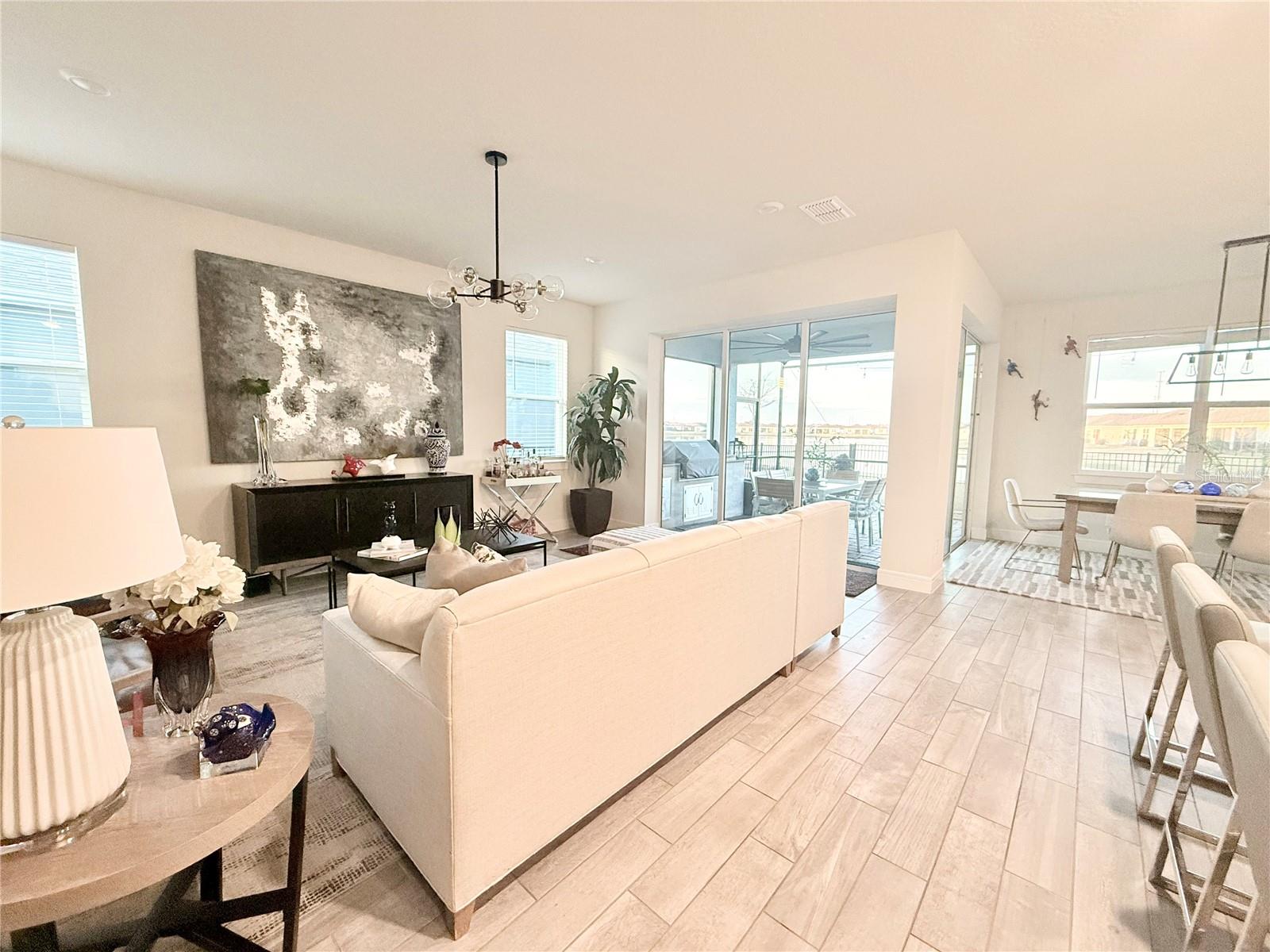 THIS IS MORE THAN A HOME — IT’S A LIFESTYLE.Experience elevated living in this exceptional builder’s model home, located in the highly sought-after 55+ gated community of Tohoqua Reserve, now completely sold out.Built in 2022 and showcasing the builder’s highest level of upgrades, this residence offers a perfect blend of elegance, comfort, and modern Florida living.The heart of the home features a stunning open-concept kitchen designed to seamlessly connect with the living and dining areas, creating an ideal space for both everyday living and entertaining. Two expansive sliding glass doors fill the home with natural light and open to the fully screened lanai, creating a seamless indoor-outdoor lifestyle experience.Step outside to your private, fully fenced backyard overlooking a peaceful lake, where you’ll enjoy breathtaking sunsets and serene water views. The extended screened enclosure covers the entire patio area, enhanced by a custom outdoor KitchenAid built-in grill and cabinet, creating the ultimate outdoor entertaining space.The thoughtfully designed floor plan includes 3 spacious bedrooms, 2 full bathrooms, and a private flex room with elegant double doors, ideal for a home office, guest room, or creative space.The 2-car garage features a premium epoxy-coated floor, delivering both durability and a clean, luxury finish.As a resident, enjoy exclusive access to the private Tohoqua Reserve clubhouse, featuring:* Resort-style pool* State-of-the-art fitness center* Pickleball and bocce courts* Private social loungePlus full access to the Tohoqua Master Amenity Center, including resort pools, tennis courts, fitness center, playground, and entertainment areas.Model home. Lakefront setting. Premium upgrades. Screened outdoor living. Sold-out community.