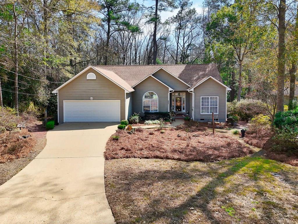 Location, affordability, and move-in ready! This beautiful 3-bedroom, 2-bath home is located in the desirable Pine Summit subdivision, conveniently close to local schools, shopping, and less than 10 minutes from downtown Thomasville. One of the most desirable spots in the neighborhood, this home backs up to a large wooded tract, offering exceptional privacy and a peaceful setting, perfect for quiet afternoons and relaxed backyard grill-outs. Inside, you'll find a bright and airy open-concept layout featuring a combined living room, dining area, and kitchen, perfect for everyday living and entertaining. The primary suite offers a comfortable retreat with a spacious en-suite bathroom that includes a garden tub, separate shower, double vanities, and a walk-in closet. Step outside to enjoy time in the fresh air on the back deck, or tend to the garden area. A backyard storage shed provides additional space for tools and equipment. The former owner was an avid gardener, and the yard comes alive with beautiful blooms each spring. See photos at the end for last spring's display. This home is not subject to an HOA.