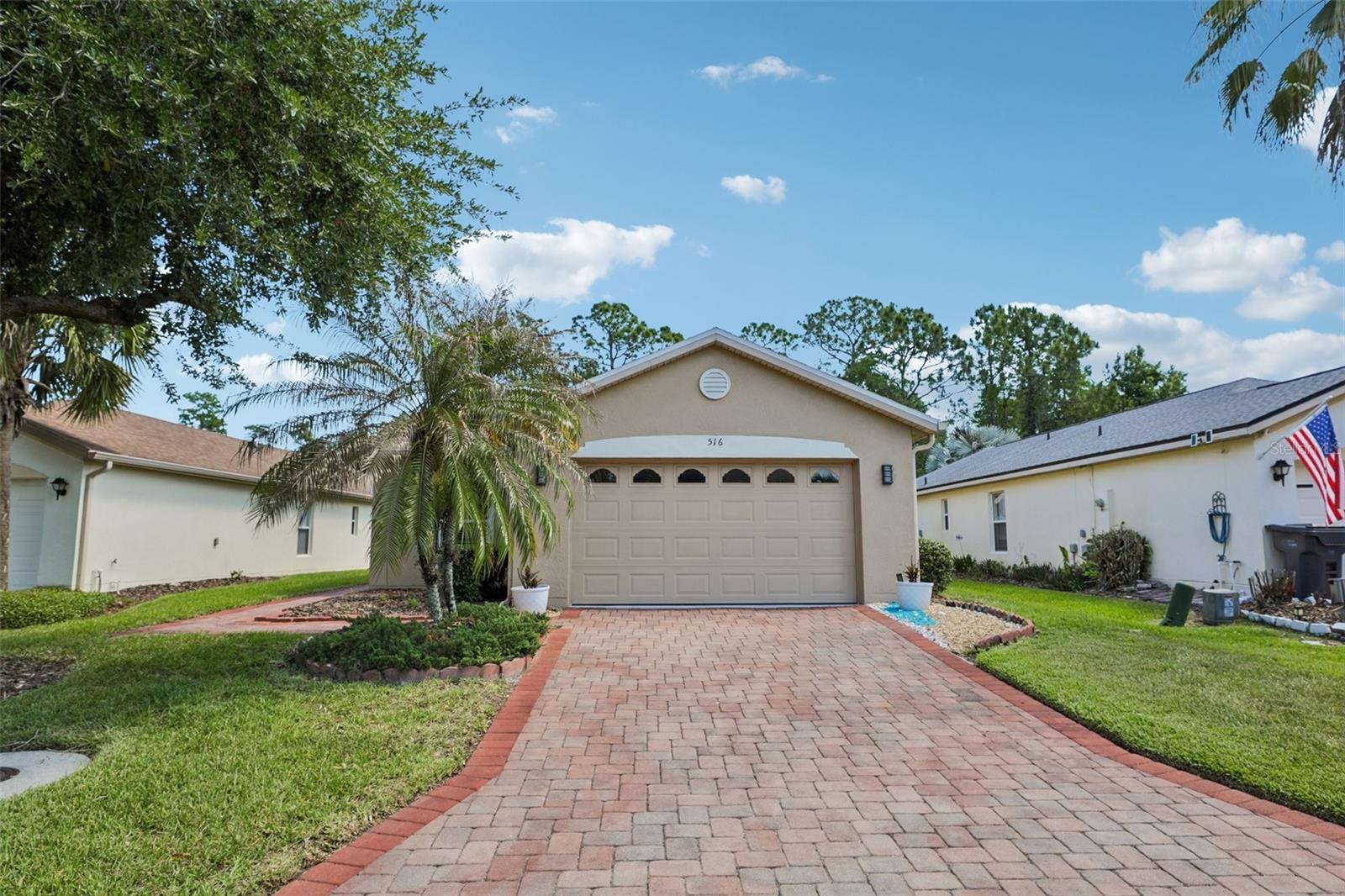 Welcome home to effortless living. This charming 2-bedroom, 2-bathroom Spanish-style residence offers 1,240 sq ft of thoughtfully designed living space in the heart of Solivita's 55+ gated golf community. Move-in ready and recently updated, this home features a modern paint refresh, new lighting throughout, updated faucets, and new door hardware. The open-concept layout centers around a generous GREAT ROOM with a split floor plan—perfect for both daily living and entertaining. The heart of the home showcases a spacious, upgraded kitchen with stainless-steel appliances, solid bright wood cabinetry with convenient pull-out drawers, and a welcoming breakfast bar. The Owner's Suite is a true retreat, complete with a walk-in closet, linen closet, and a spa-like En-Suite Master Bathroom featuring an upgraded walk-in shower with a new glass door, premium faucets, and new fixtures. Enjoy a covered 10' × 10' screened lanai with pavers, plus two additional paver sitting areas—all framed by mature conservation trees. An extended paver walkway invites you to relax and unwind. Window tinting keeps the home cool and comfortable. Practical touches include a washer/dryer inside the home and a one-car garage with dedicated golf cart space. This cul-de-sac home offers minimal traffic and conservation views, while providing access to two PGA Championship golf courses, 14 pools, fine dining, state-of-the-art amenity centers, tennis and pickleball courts, and 200+ clubs. Located just 25 minutes from major attractions and the new SunRail Poinciana Station. Schedule your private showing today.