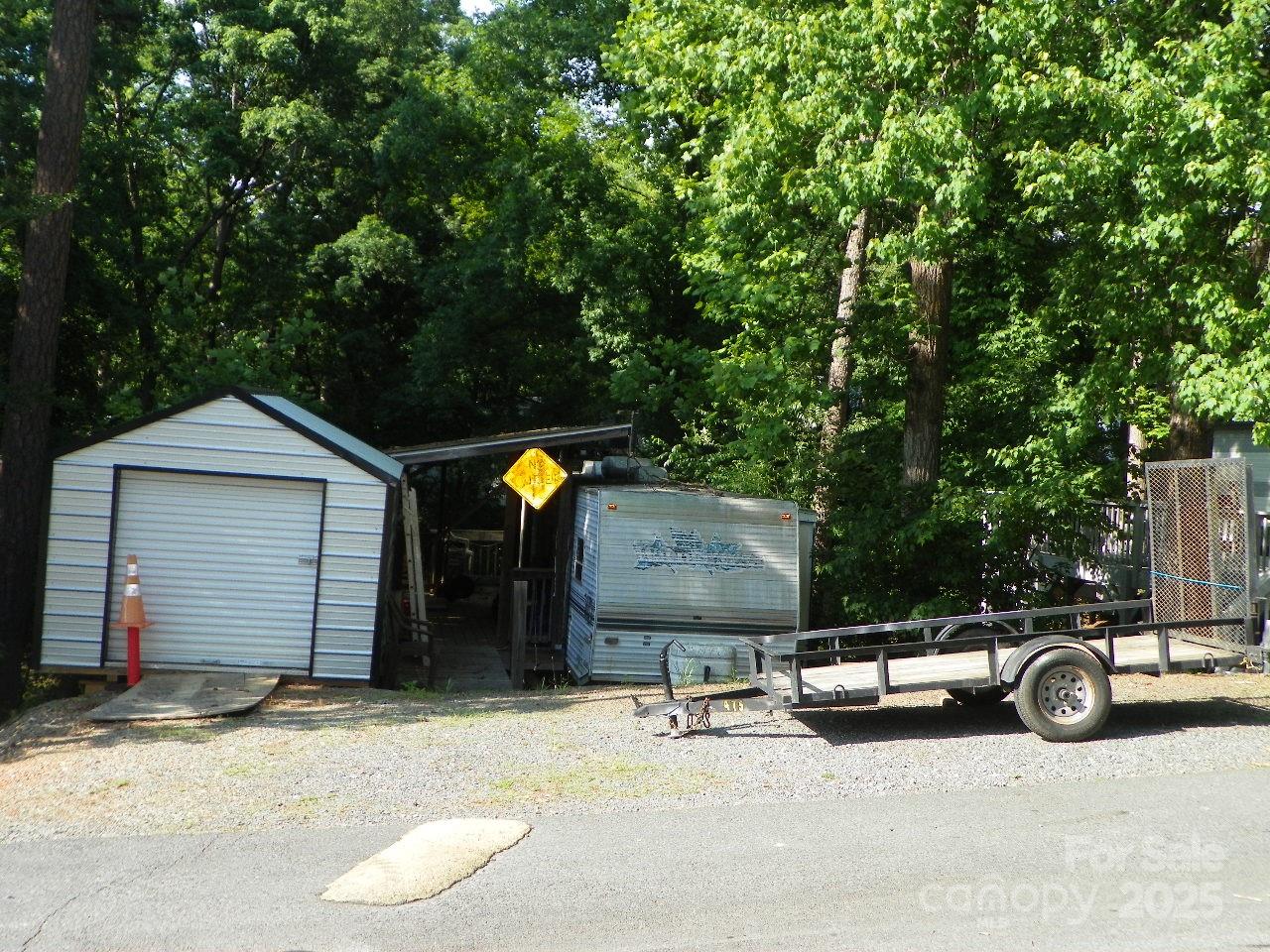 Located in the great gated community of Badin Shores RV Resort. The camper that is on the lot will be removed by the seller.  Storage building and covered porch to remain. Enjoy full time living or that wonderful Lake Getaway!!
1 Hr. from Greensboro and Charlotte with major Air ports. Summer is here!!  come take a look at this wonderful Community with Great amenities for the entire family!!  Clubhouse ( may be reserved for personal use for a small fee), Chapel, Swimming pool and kiddie pool, Basket ball, Pickel ball, play grounds, Fishing Pier, Sandy beach, work out center, Restaurant/Marina, Putt-putt, water front boardwalk, "Take that romantic stroll in the moon light"!!! 24 hr. security.
Must take a look, might be just what you have been looking for!!
This lot is near ALL the amenities!!!