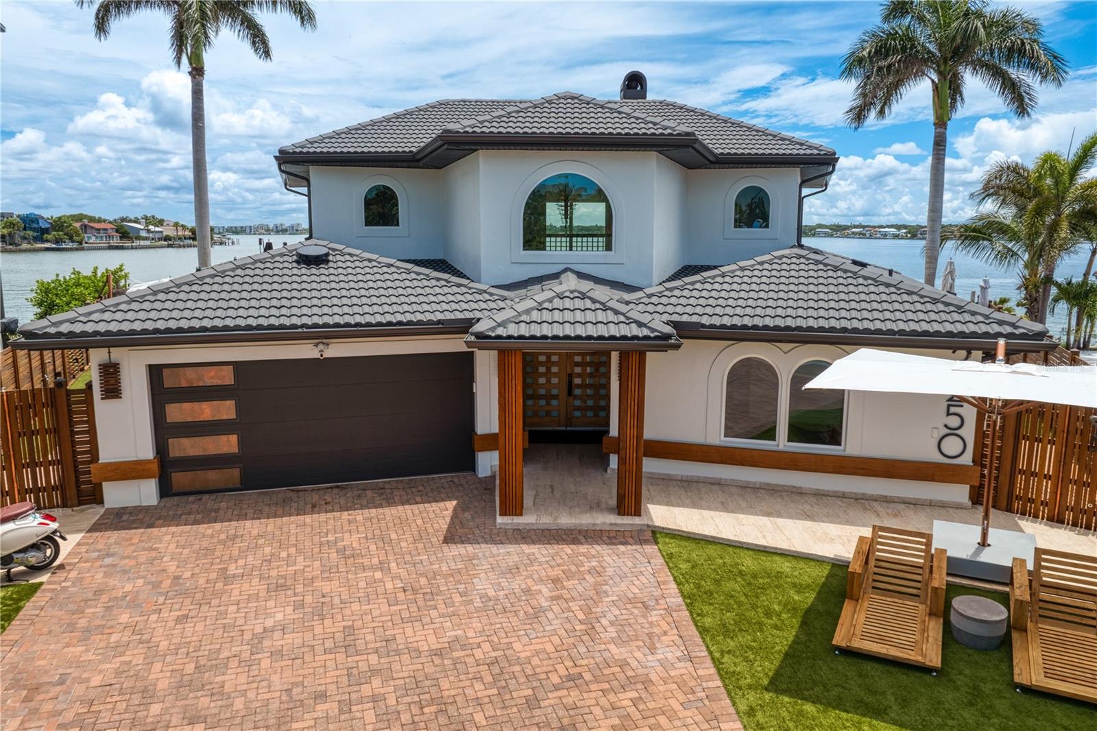 So the home is situated at the end of a cul-de-sac on a 120’ Foot Point Lot surrounded by the Intracoastal Waterway that descends into Clearwaters’ Harbor. Located within the tony Bastion that is Belleair Beach- well known for its’ privacy, security and beach access restricted beaches. If you recall the highest sale to have ever transacted in Pinellas County history happened just around the corner a few years back. Now, we offer this home for what it is- Either Lot Value or Wholly Capable of An Interior Build Out, Which Would Run around $300k. The interior is a shell that was intended to be someone locals Forever home, but as we’ve learned Forever is a very long time, and now it’s current steward is off to start a new, yet reoccurring chapter in Southeast Asia. The painstaking effort towards the Brazilian hardwoods, and all materials exhibited on the exterior is obvious. One can envision a modern steel and glass sculpture of a home sitting on this lot which would without a doubt present the most compelling Water Vista within the Belleairs.
