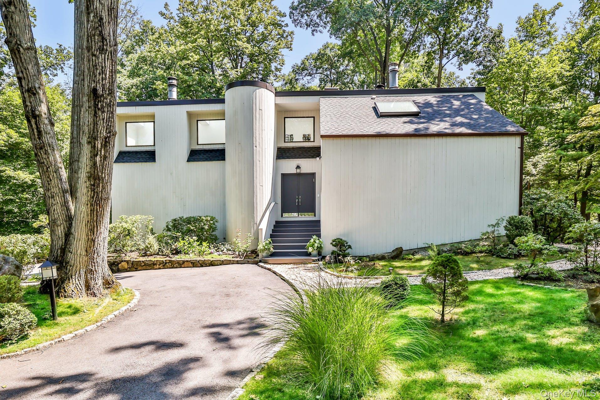 Exceptionally renovated and truly turnkey, this striking Whippoorwill cul-de-sac Contemporary is located in the highly acclaimed Chappaqua School District. Dramatic, airy, and light-filled, the 4-bedroom home is set in a serene and sought-after neighborhood, offering both privacy and convenience. A wall of windows, skylights, soaring ceilings, and an open floor plan flood the interiors with natural light. The living and family rooms—each featuring a fireplace—flow seamlessly for effortless everyday living and entertaining. Hardwood floors extend throughout, while outdoor spaces include a stone patio and wraparound deck overlooking lush, park-like grounds. Extensive upgrades include new above-ground oil tanks, new windows, a new roof, new mechanicals, and more. Enjoy lake rights to Whippoorwill Lake and easy walking access to the Whippoorwill trails. This exceptional home is a rare offering and sure to delight the most discerning buyer.