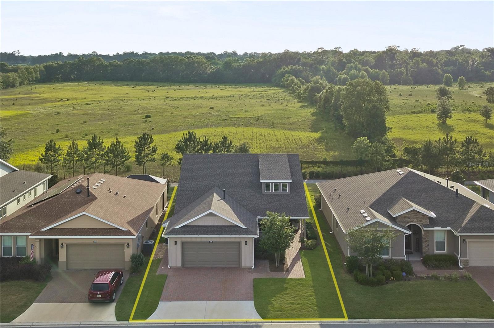 Welcome to this beautiful Shea-built Monaco model in the highly sought-after 55+ Trilogy section of Ocala Preserve! With fresh landscaping, NO CDD, and a premium lot with NO REAR NEIGHBORS, this home has so much to offer! Conveniently located just minutes from WEC, HITS, FAST, shopping, dining, and more, you'll love everything about this location. With nearly 1,700 square feet of living space and a 2-foot extension to the floor plan, this thoughtfully designed home features 2 bedrooms, 2 bathrooms, a versatile den, and plenty of room to entertain. Beautiful tile flooring, soaring ceilings, and oversized windows welcome you inside, filling the home with natural light and offering peaceful views of the open space behind the property. The open floor plan flows beautifully from the living area into the dining space and spacious kitchen, complete with granite countertops, stainless steel appliances, a gas stove, under-cabinet lighting, an interior island, a large peninsula, abundant cabinetry, and a deep pantry. A charming breakfast nook surrounded by windows is the perfect place to enjoy your morning coffee. The split bedroom floor plan provides privacy, with the spacious owner's suite overlooking the backyard and offering beautiful western sunset views. The en-suite bathroom features dual vanities, a tiled walk-in shower with seamless glass doors, and a custom walk-in closet. The guest bedroom offers generous closet space, while the guest bathroom features a stone-topped vanity and tiled walk-in shower with glass enclosure. The den is perfect for a home office, additional sitting area, or hobby room and offers direct access to the screened lanai. Outside, you'll find an extended paver patio, oversized umbrella shade, and a peaceful backyard with no rear neighbors! Whether you're entertaining friends, grilling, or simply enjoying the Florida weather, this outdoor space is a wonderful extension of the home. Additional features include a spacious laundry room with utility sink and storage, an epoxied garage floor with additional shelving, and a whole-home water softener system. Just a short walk to the clubhouse, you'll have access to everything that makes Ocala Preserve such a special place to call home! Enjoy resort-style and lap pools, a fitness center and spa, tennis, pickleball, bocce, walking trails, a beautiful lakeside veranda and boardwalk, on-site dining, social clubs, and a full calendar of activities. Whether you're looking for an active lifestyle or a quiet place to relax, this community offers the best of both worlds. With its extended floor plan, private backyard, fresh landscaping, and beautiful upgrades, this home is ready for its next owner. Schedule your private showing today!