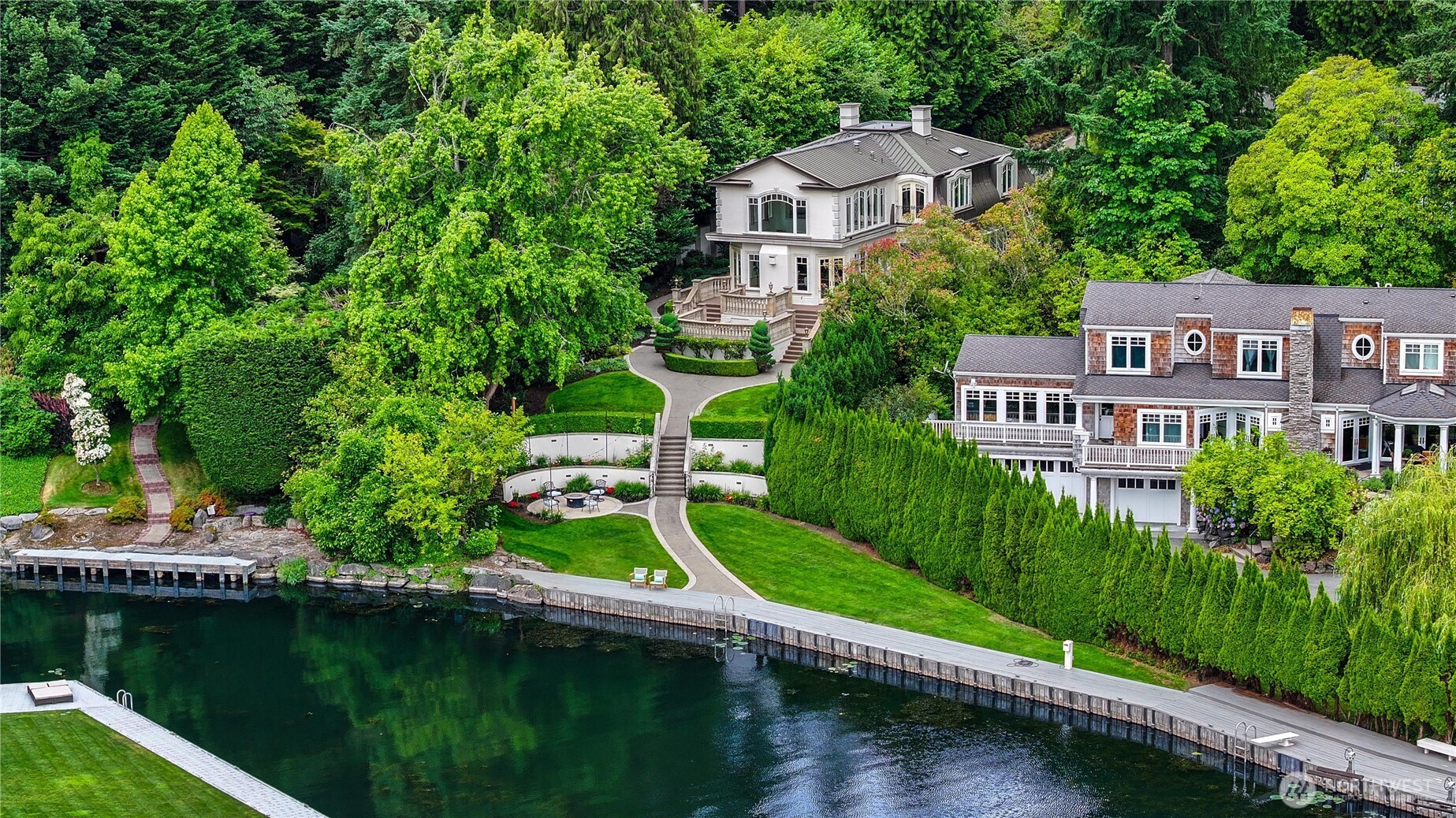 A distinctive gated estate in one of the nation’s most coveted neighborhoods. This Mediterranean-style residence features cathedral ceilings, Italian columns, and French doors opening to serene patios and a 200-ft dock with year-round moorage. Gorgeous wrought iron railings, crystal chandeliers, and a whole-house sound system add to the refined ambiance. Each bedroom is an ensuite. Downstairs offers relaxation with a wine cellar, spa, cold bar and terraces. Chef’s kitchen is outfitted with brand-name appliances. Curved design flows through the lush, landscaped grounds of this Lake Washington shore house. Mature trees, vibrant blooms, and curated shrubs welcome visits from blue herons and bald eagles. Fountain, BBQ island, firepit, dog run.