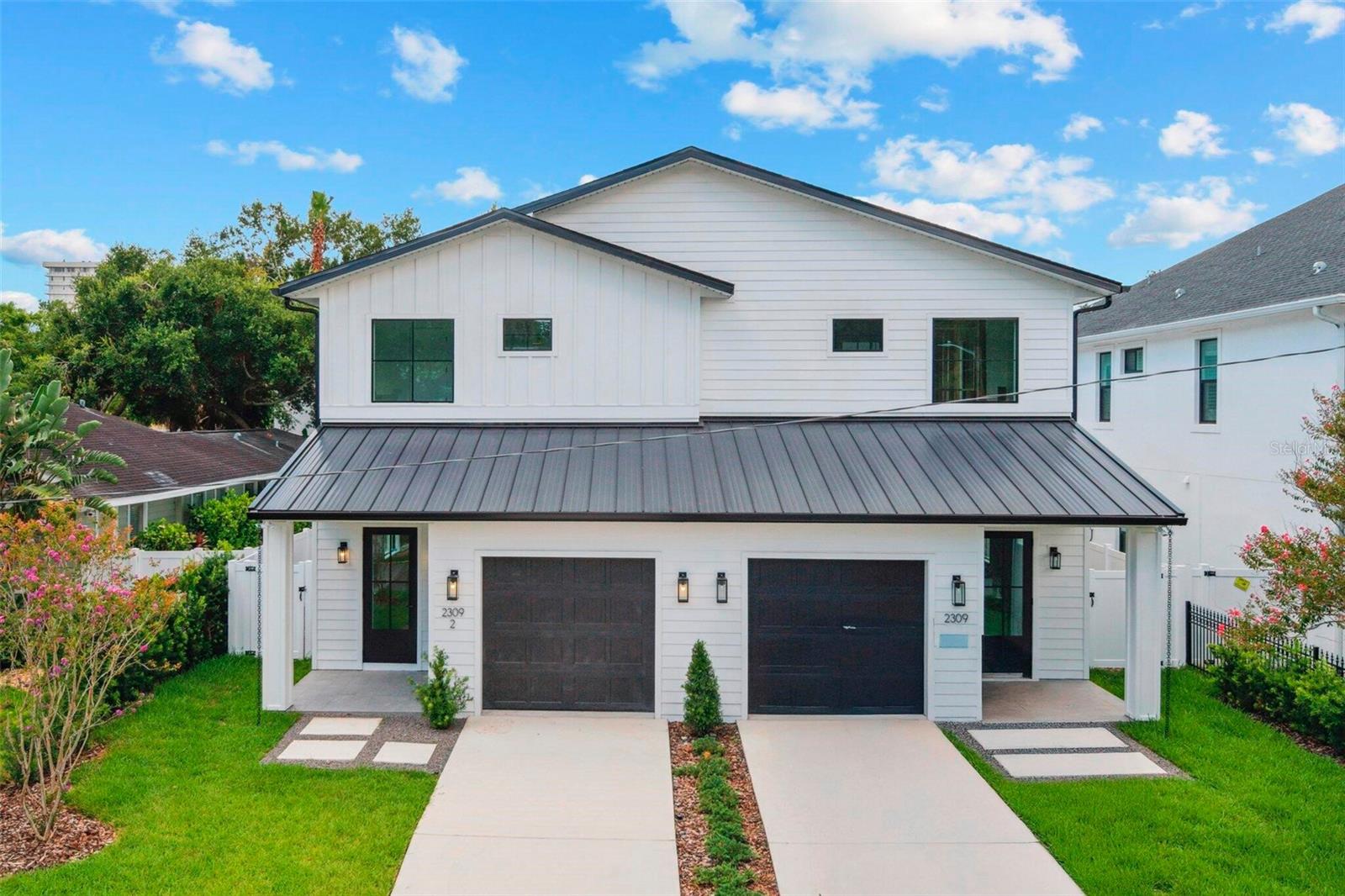NEW CONSTRUCTION. Upscale Modern Farmhouse townhome in highly desired South Tampa neighborhood. Views of the Bay from front yard. Walking distance to Bayshore Boulevard, Howard Ave and Hyde Park Village. Unit contains 4 bedrooms, an office, and 3.5 baths. Highlights: Hardwood floors, gas fireplace, large covered back patio with generous green space (plumbed for outdoor kitchen and TV), large and many windows, dry bar with wine cooler, standalone tub in master bath, 2 walk in closets in master, pot filler over gas range, 10 Ft ceilings on both levels, Upgraded GE Monogram Appliances.