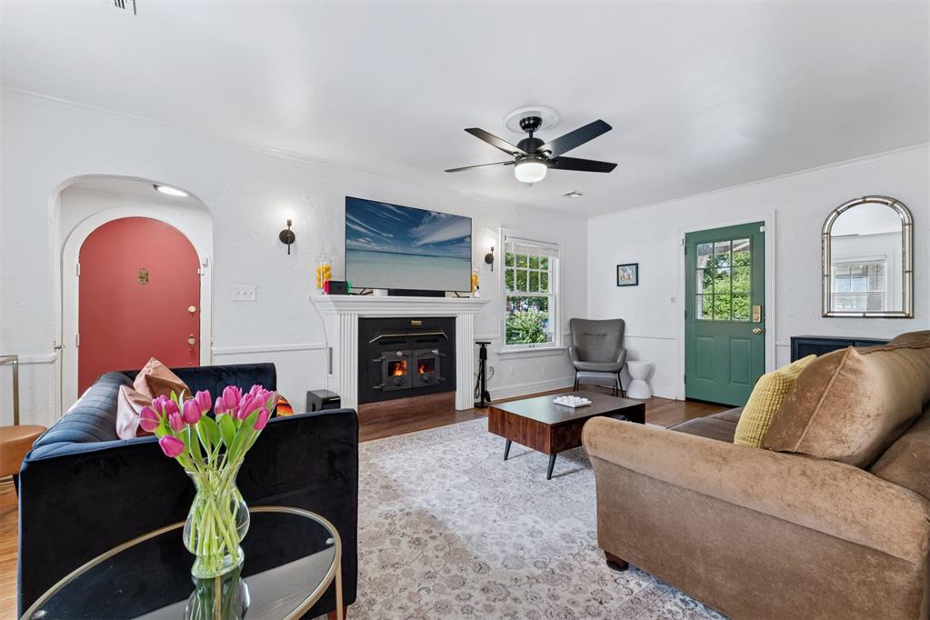 This 1934 storybook English Tudor in Historic Preservation Crown Heights is full of charm and the kind of updates that make everyday living easy! The curb appeal pulls you in right away with sidewalks, mature trees, lush landscaping, and a covered side porch that’s perfect for morning coffee or winding down in the evenings. Inside, you’ll find refinished original oak hardwood floors, arched doorways, and a cozy wood-burning stove that highlight all the best 1930s character. The bright living room flows into the accommodating formal dining space and then to a built-in butler’s pantry that’s perfect for a coffee or cocktail bar. The kitchen offers granite counters, stainless steel appliances, a gas range, and a pantry for extra storage. Two bedrooms on the main level share a hall bath with classic black-and-white tile and a cast iron tub/shower combo. Upstairs is a true retreat - the private primary suite includes its own additional living area, walk-in closet, remodeled en suite bath, and a balcony overlooking the beautifully landscaped yard. Downstairs, the finished basement adds even more flexibility: one half is styled as a den, perfect for a studio, game room, or extra living space, while the other half houses a large laundry and utility room with tons of storage. Big-ticket updates offer peace of mind, including a brand-new roof and gutters on both the house and garage, a new furnace, newer hot water tank, newer driveway, newer gas line, and more! All of this is tucked onto a quiet, tree-lined street just minutes from Western Avenue, The Paseo, Classen Curve, and Downtown. This home is full of character, thoughtfully updated by loving owners, and in such a great location - schedule a private showing!