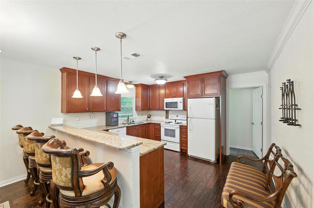 Location! Location! Location! This Property has been updated.  Exterior features include an inviting drive-up appeal with wood frame and siding exterior, covered front porch, huge lot with long driveway and concrete parking pad, maintained grounds with trees, and a backyard deck that faces the creek. Interior features include an open concept with combination living area and dining open to the kitchen. The kitchen and dining are separated by a long breakfast bar. The kitchen includes a dishwasher, sink, microwave, and electric range. There are 2 bedrooms with ensuite bathrooms, and a laundry room with room for a full-size washer and dryer. This property is a MUST SEE full of potential in the heart of a thriving business and high-end home community. Currently zoned R20 for residential use with surrounding properties zoned CC1, CN and R20. Buyer to verify zoning with the City of Colleyville Planning Commission. Buyer will be responsible for rezoning after closing and funding. Buyer to verify any rezoning allowance for any planned use. The Sellers also have 2 ADDITIONAL LOCATIONS FOR SALE: 5017 Colleyville Blvd zoned CC1-Village Retail w City approved Grant to assist w improvements (MLS 21166944)& 450 W Harwood in Hurst zoned PD (MLS 21138314). Buyer to verify all details & information provided. For more information, see the Transaction Desk.