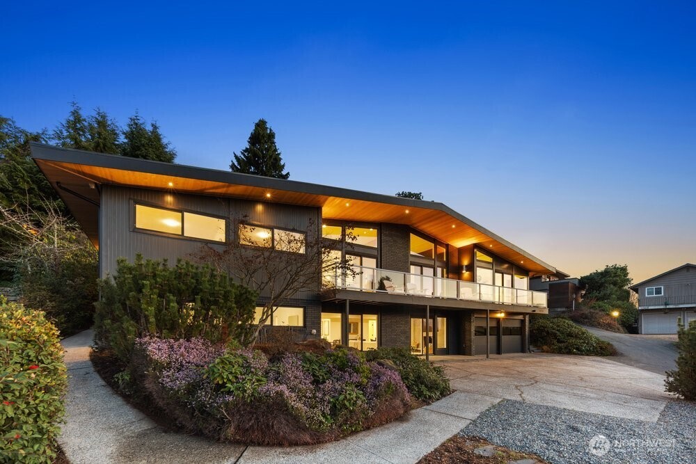 Stunning mid century modern gem that has been fully remodeled from the inside out. This luxury home is perched perfectly to showcase the sweeping views of the Olympic mountains, Vashon island and the sound. Vaulted ceilings with large windows give this home abundant day light and incredible sunsets. Open areas make it perfect for entertainment and living life. High end designer finishes throughout the home with no detail spared. Kitchen features quartz waterfall island and luxury appliances with beautiful tile accents along with hookups for 2nd laundry. Primary bedroom with bathroom including a large custom walk in shower and heated flooring. Permitted remodel with all new Hvac system heatpump w/ AC, windows, roof, electrical and plumbing. Too many upgrades to list. Lower level also has sound and mountain views and is set up with its own entrance, full kitchen, bath and 2 bedrooms with plenty of living space. This home offers lots of flexible options with multifamily living, in-law or even possible STR. Use the complete home or convert the lower level into an ADU. Epoxy floor in garage with EV charger. Outdoor spaces and rear porch are well positioned to provide privacy and easy maintenance.