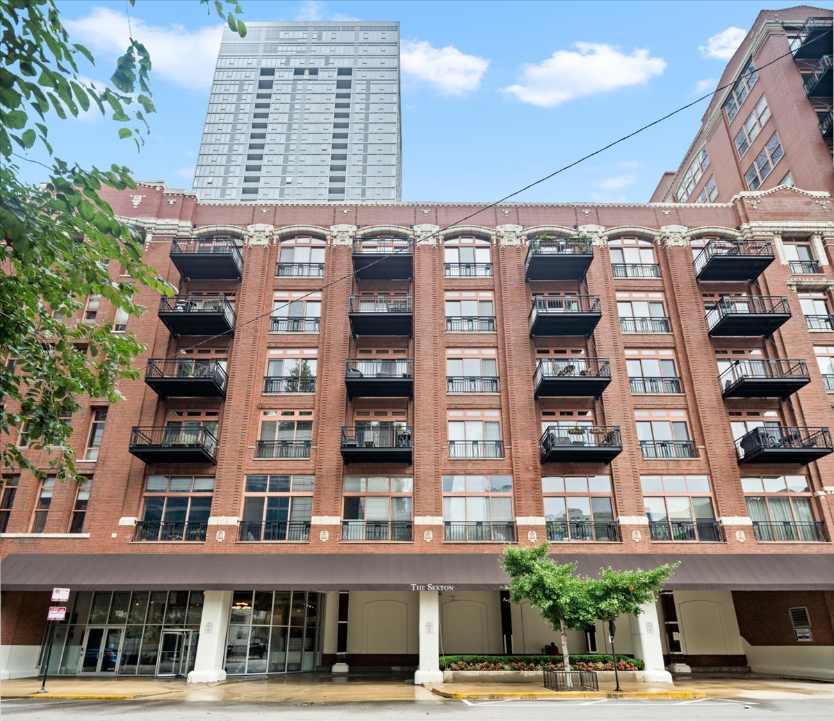 Sought-after city living in this quiet River North corridor, just steps from East Bank Club, the Riverwalk, and Chicago's best dining - Bavette's, Gilt Bar, Ciccio Mio, the list goes on. This soaring 13' concrete loft features two fully enclosed bedrooms, expansive living/dining space outfitted with gleaming hardwoods and cook's kitchen featuring suite of stainless steel appliances, dark granite counters, plus island with ample stool seating. Expansive shared bathroom w/ private principal suite access through its massive walk-in closet. Ideal private outdoor space framed by towering tree views creates true privacy. Extensive storage throughout plus additional building storage. In-unit washer/dryer. Oversized end-spot parking INCLUDED. Amenity-filled building offers doorman, exercise facility, and common courtyard. The true definition of city living in a quiet yet connected Chicago corridor. This is it.