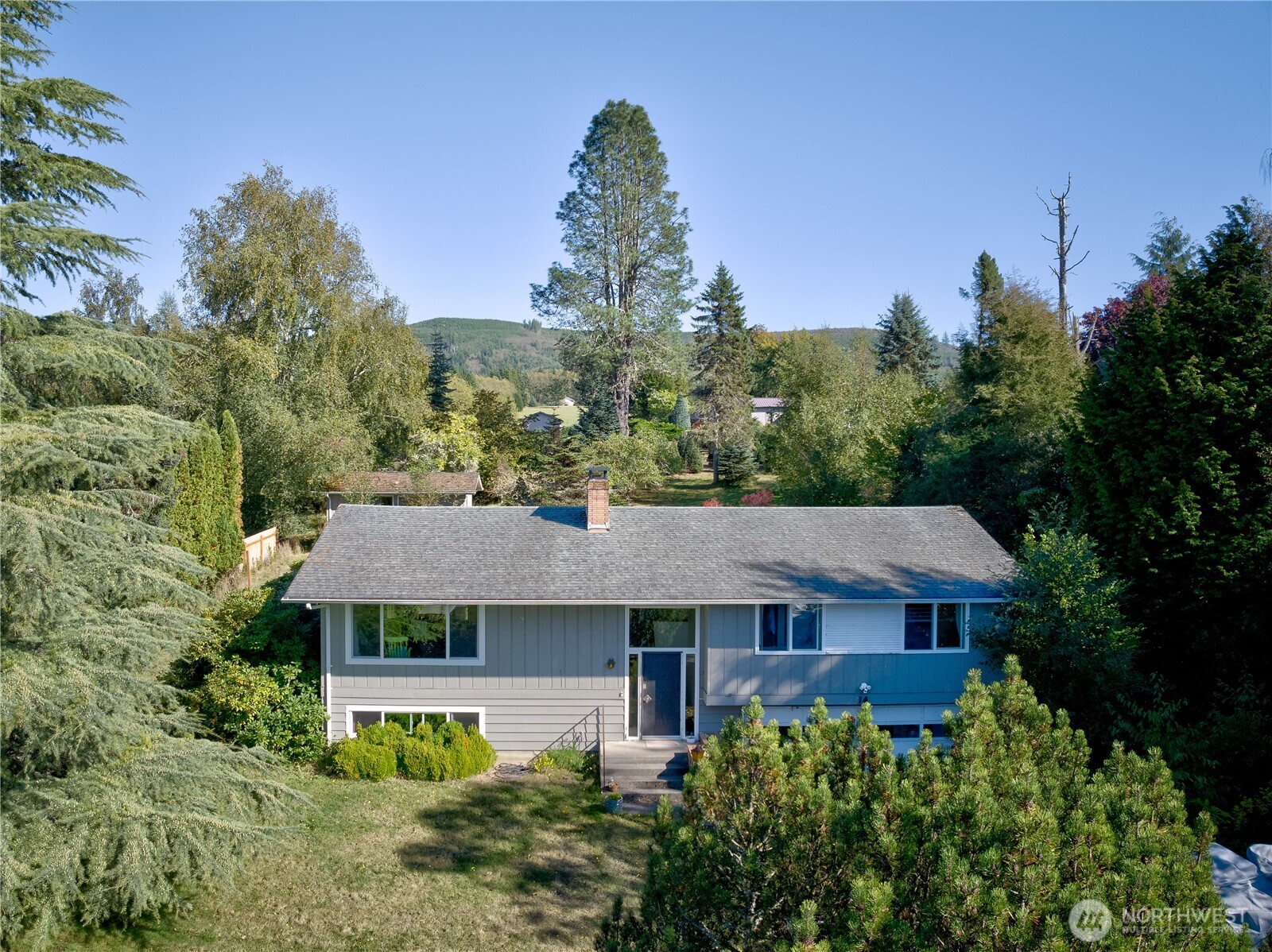 Large split-level home next to the Skyline Golf Course in Cathlamet. Home is on a quiet dead-end street on half an acre. Peaceful backyard has fruit trees & bushes, a 13'x22' outbuilding with power, room to put in a garden, and partially fenced to let your dog(s) roam and play. 3 bedrooms 2 bath on the upper level, new appliances in the kitchen, views of Puget Island from the living room window, and a wood fireplace to warm the upstairs or create a cozy setting during the winter. Lower level has many possibilities with it's open main room - make it an office, storage, large TV/Game room or extra bedroom. There's another bathroom on the lower level with a washer/dryer, and a 2nd wood fireplace in the main room. Attached 2-car garage plus an electric car charging station in the driveway.