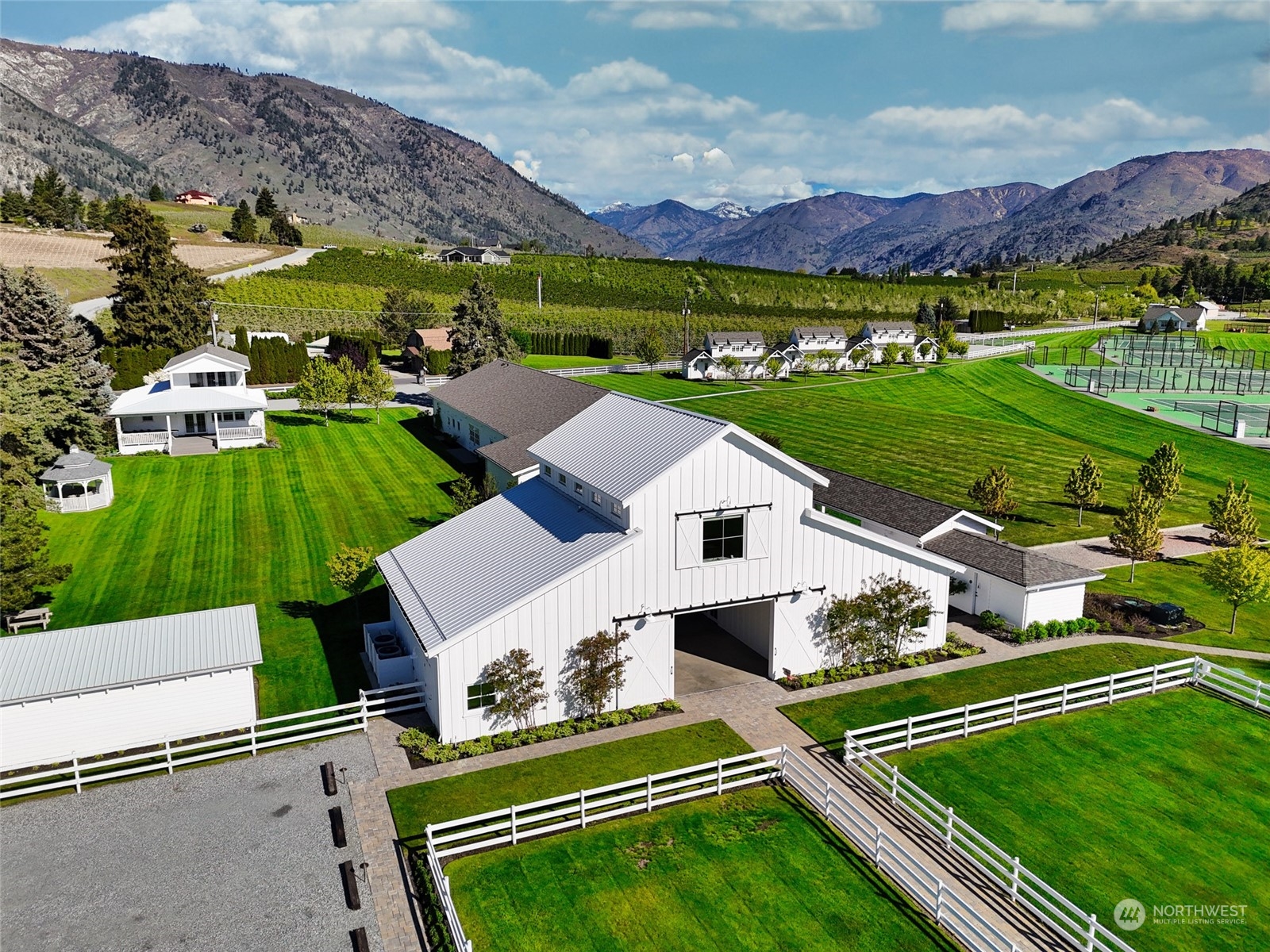 Welcome to the Lake Chelan Retreat, where luxury living meets natural beauty near Manson, WA. Spanning 12+/- acres, this sanctuary offers a thriving venue amidst picturesque mountains and lakes. The venue is known for hosting upscale weddings, corporate retreats, and esteemed tennis camps. The 7,360 sq ft event hall sets the stage for unforgettable gatherings. Nine charming cottages as well as three luxurious suites in the Inn provide comfort for all your guests. For tennis enthusiasts, eight professional-level Laykold Masters courts promise endless enjoyment. Caretakers house on site as well. Surrounded by pristine shoreline and award-winning wineries, this venue and its location is sure to leave you speechless.