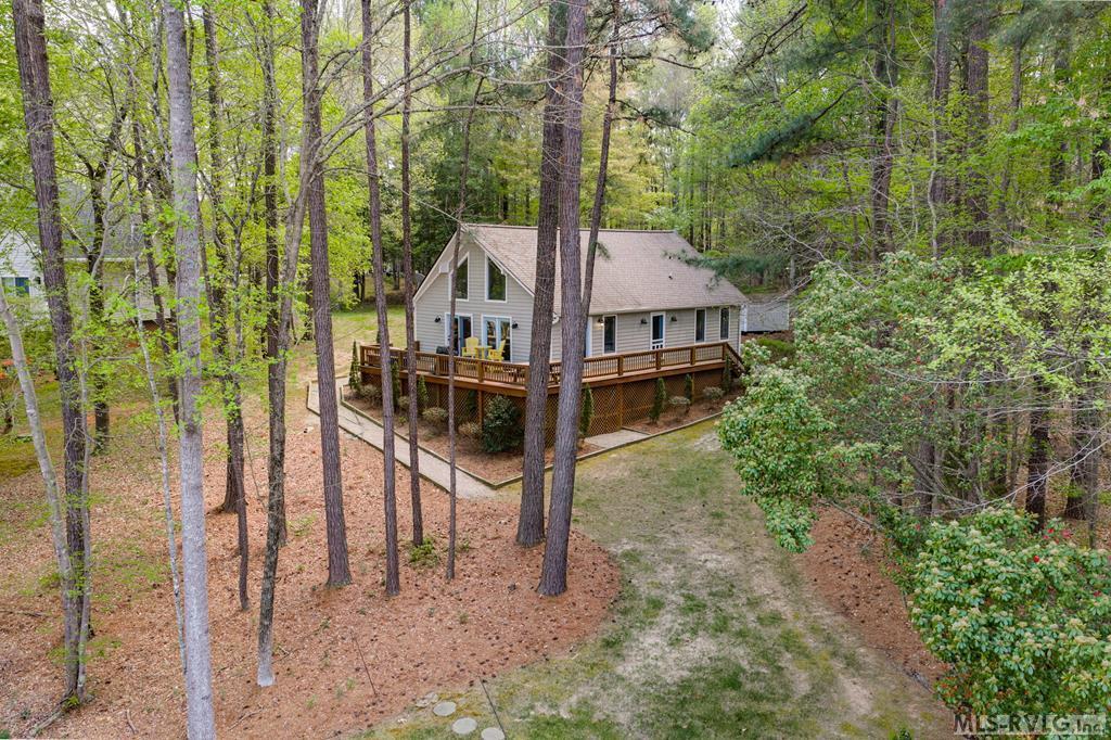 This is a true turnkey offering on Lake Gaston! What a great A-frame home on a flat lot with 3 bedrooms, 3 full baths, 1 flex room, and coming fully furnished. The property has a double boathouse with a wonderful 4.5-5 feet of water at the end and sits in Poe Creek in the highly sought after SE Quad. Just a 5 minute boat ride and you are on the main lake. Per the prior owner in 2023 the house was painted and new gutters installed as well as gutter guards. A new gas pak was installed in 2019. The lot is bulkheaded and because of the location makes for a great swimming area at the dock. No wakes and boat traffic to deal with and no bridges to cross under making your choice of boat unlimited. Top this off with a community pool and community boat ramp so you or your guests can put in other watercraft and it makes this property a must see!