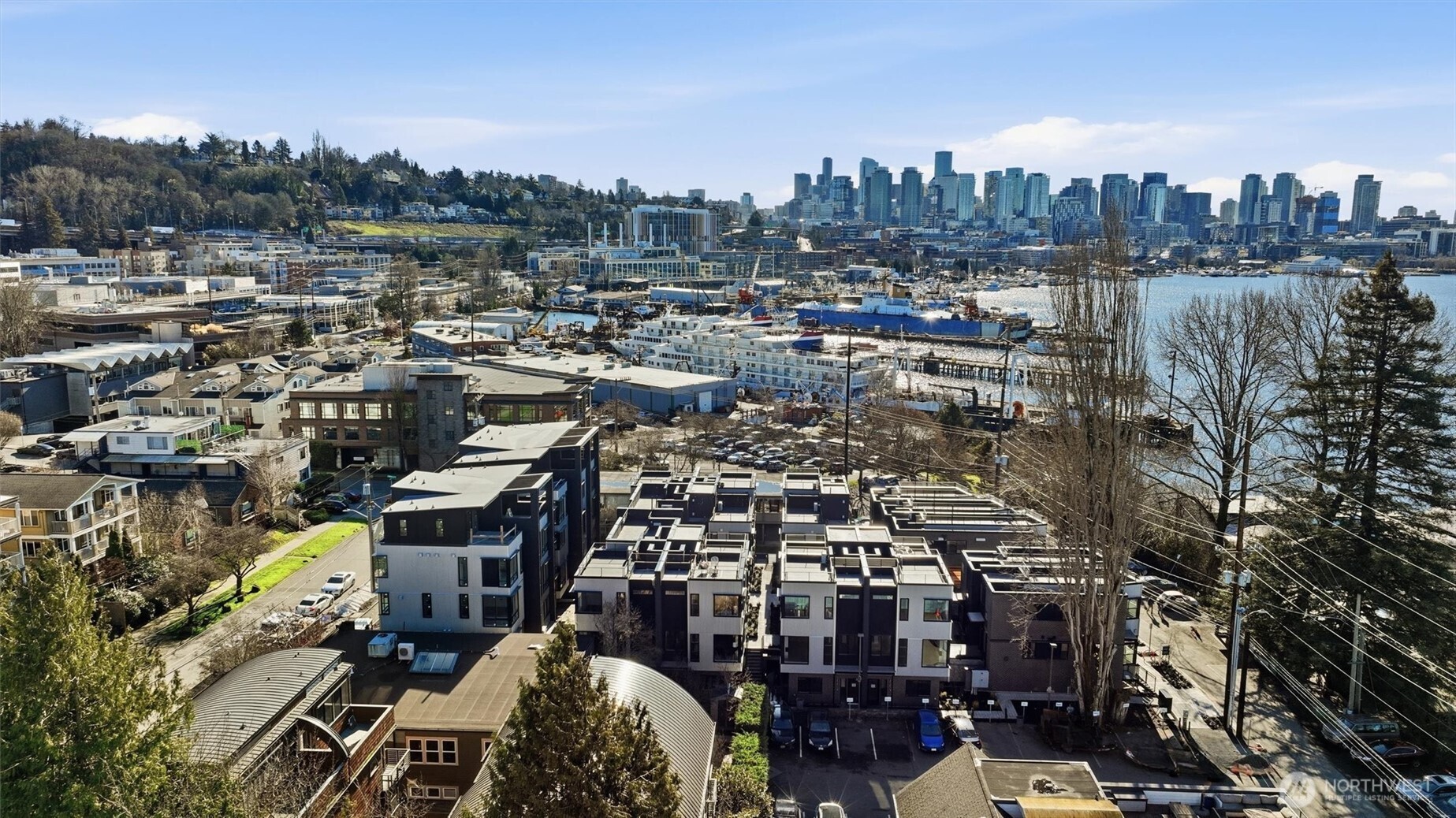 Positioned in the heart of Eastlake, this 2 bed, 2.5 bath residence at Harbor 26 offers 1,307 sqft of well-balanced living with a focus on comfort and function. The open-concept main level connects living, dining, and kitchen spaces seamlessly, with clean lines, modern finishes, and thoughtful design throughout. Both bedrooms are generously sized, each with its own bath, while the additional powder room adds everyday convenience. Above it all, a private rooftop deck captures expansive views of Lake Union and the Seattle skyline—an elevated extension of your living space. Located within a gated community and complete with secured garage parking, this home delivers a quieter, more refined take on waterfront-adjacent living. Crafted by DEP Homes Eastlake, known for consistent quality and intentional design. **Preferred lender rate buydown, 1% off todays current rates + lender credit to cover buyer closing costs & no fees on future refinance**