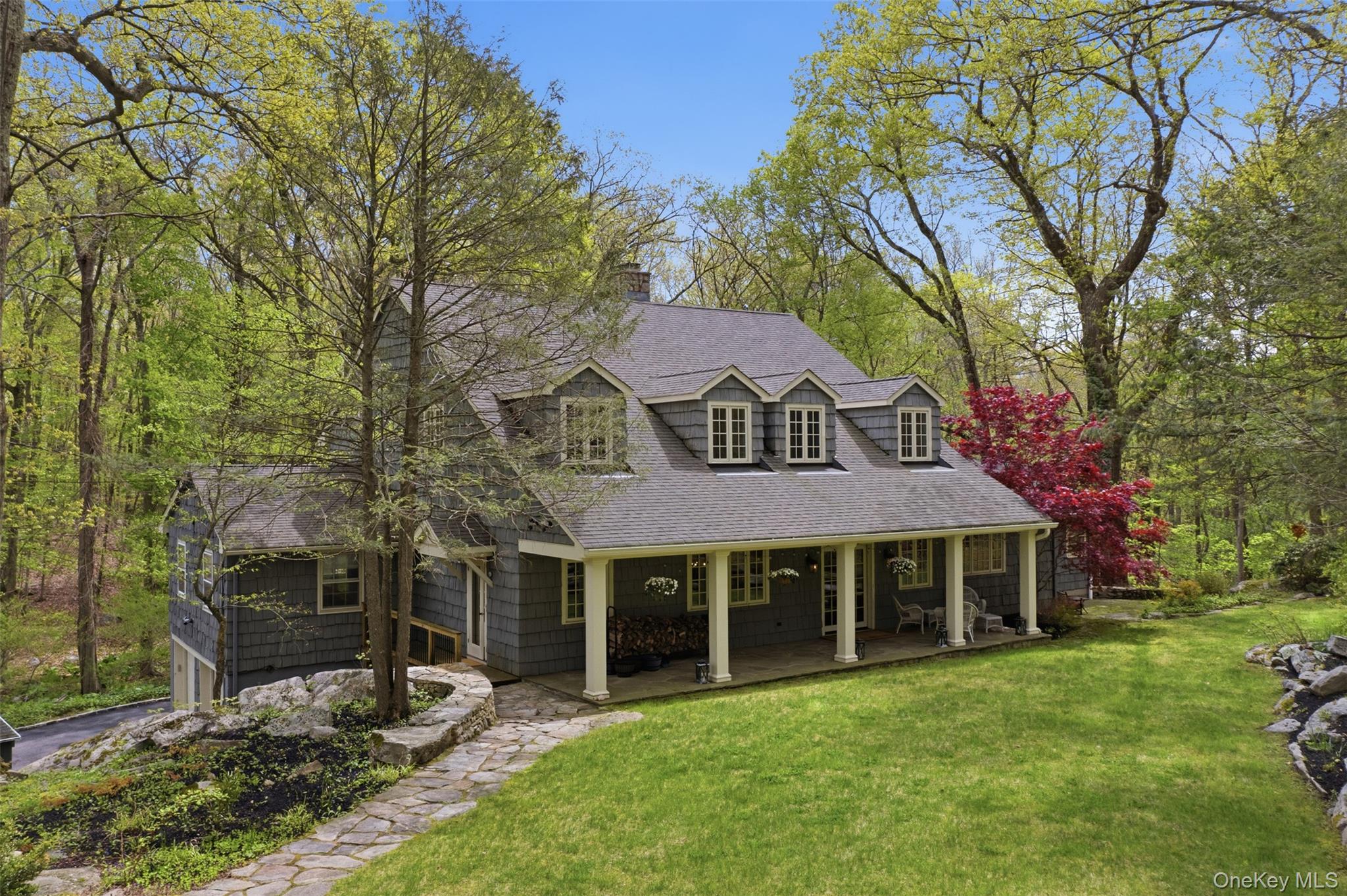 Calling all nature lovers! This award winning (American Institute of Architects Design Award) farmhouse, is a woodland paradise. Set at the end of a private road, with stone outcroppings and it's own mini trail system, this is a quiet retreat with all the updates. An entertainer's dream; this home is equipped with a chef's kitchen featuring custom cabinets, vaulted ceilings, a new butcher block island, and both a front porch and back deck. Oversized windows create natural light and stunning views throughout. This spacious interior creates ultimate flexibility. With the first floor en-suite opening to a stone patio, and the second level primary featuring custom walk in closets, and updated spa bath. This feels like a 5 bedroom (or more). Additional features include: The lower level with a walk-out, two laundry options, and multiple flex spaces. It is ready for what you need.  Recent updates include: Whole house automatic generator, new hot water tank, water filtration systems, new HVAC system for main and lower levels, exterior lighting, and a brand new driveway with ample parking.