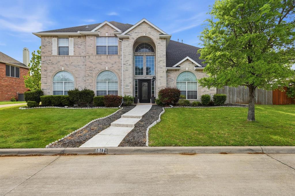 Step into this captivating home that blends timeless elegance with practicality. Situated in a prime location near top-rated schools, vibrant shopping and dining at Lakeside and Riverwalk, and picturesque trails. With DFW Airport just 10 minutes away, convenience meets sophistication. Nestled on a peaceful, secluded road, this home boasts a light-colored brick exterior that shines brilliantly under custom-installed uplighting. The grand entrance welcomes you with gleaming wood floors and a stunning staircase. To the right, the formal living and dining rooms exude charm, complete with stylish light fixtures. The heart of the home is its expansive open-plan living area, featuring a vaulted family room with a cozy gas fireplace. The gourmet kitchen is a chef's dream, offering granite countertops, generous cabinetry. Retreat to the main-floor master suite, a serene haven with room for a sitting area and beautiful arched windows that invite natural light. The spa-like ensuite boasts a corner bathtub, separate shower, and dual vanity sinks.Upstairs offers three spacious bedrooms, a Jack-and-Jill bath with separate vanities, a media room, an office or bonus room, and another full bathroom with dual sinks. The massive backyard is an entertainer’s paradise, ready for your vision—be it a pool, playground, outdoor kitchen, or pergola. The patio is perfect for gatherings, while the well-kept front yard requires minimal effort. Recent upgrades include a new roof (2018), a replaced AC unit (2021), and 12 brand-new windows (Oct 2024), paint (2026), Primary Bath Upgrades - mirrors, light fixtures and handles (2026).