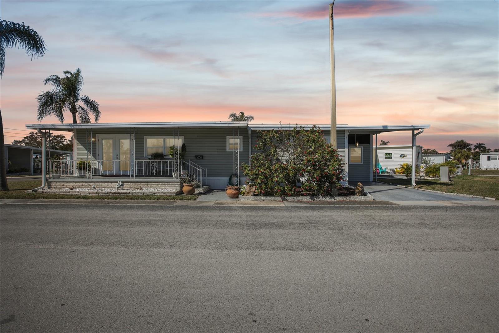 One or more photo(s) has been virtually staged. Nestled in the heart of Pinellas Park, this home presents a unique opportunity to become part of a vibrant 55+ co-op resident-owned community. This impressive triple-wide mobile home offers a harmonious blend of space, comfort, and modern amenities tailored to enhance the living experience of its residents.Upon entering, you're greeted by an expansive open living area that seamlessly connects to the elegantly renovated kitchen, complete with updated appliances. The thoughtful design maximizes functionality while providing ample space for entertaining family and friends. The home's interior has been freshly painted, lending a serene ambiance that complements the updated windows, which fill the space with natural light.The property's recent renovations extend beyond aesthetics; a new central air conditioning unit was installed in 2021, ensuring year-round comfort. The roof was updated in 2018 and comes with a warranty for added peace of mind. Durable vinyl flooring has been laid throughout the living spaces, with bathroom renovations completed in 2020, showcasing modern fixtures and finishes.This well-appointed home prioritizes convenience with indoor laundry hookups, a water softener, and abundant storage solutions. It features two carports and a double shed, providing ample space for vehicles and additional belongings.The outdoor space is equally inviting, offering a covered front patio perfect for relaxation, adorned by a charming French-style front door that creates an inviting entryway.This home stands as a testament to modern living within a welcoming 55+ community, presenting potential homeowners with the opportunity to embrace a lifestyle characterized by comfort, convenience, and community engagement.