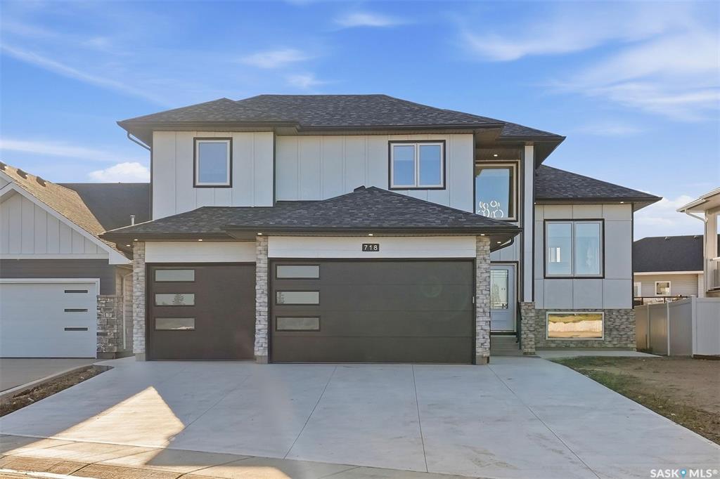 Executive Living Steps from Legends Golf Course! Stunningly designed and beautifully finished, this 1,737 sq. ft. modified bi-level is ideally situated just steps from the renowned Legends Golf Course. Offering a functional layout, quality craftsmanship, and modern finishes throughout, this move-in-ready home is sure to impress.  A grand foyer welcomes you into the bright and spacious main level, featuring an open-concept living, dining, and kitchen area designed for both everyday living and entertaining. Luxury vinyl plank and tile flooring flow throughout the main and lower levels, while 9-foot ceilings and oversized windows fill the home with natural light. The impressive kitchen features full-height cabinetry, quartz countertops, tile backsplash, a large island, and high-end stainless-steel appliances. Completing the main floor are two generous bedrooms and a stylish 4-piece bathroom.Upstairs, the spacious primary retreat offers plenty of room to relax, along with a large walk-in closet and a luxurious 5-piece ensuite.  Just off the back entrance, enjoy the large covered deck overlooking the backyard, which will be fully fenced and landscaped with grass, creating a wonderful outdoor space for relaxing or entertaining.  The fully developed lower level adds exceptional living space, featuring a cozy family room complete with a tastefully designed wet bar and electric fireplace with glass tile surround. Three additional good-sized bedrooms, a 3-piece bathroom, and a spacious utility room with tile flooring complete this level.  The triple attached heated garage provides plenty of room for vehicles, storage, and recreational equipment. Additional features include central air conditioning, all appliances, an upright refrigerator for the wet bar, and all window coverings. Furniture is negotiable.  A beautifully appointed executive home in an exceptional location—just steps from Legends Golf Course and ready to enjoy!