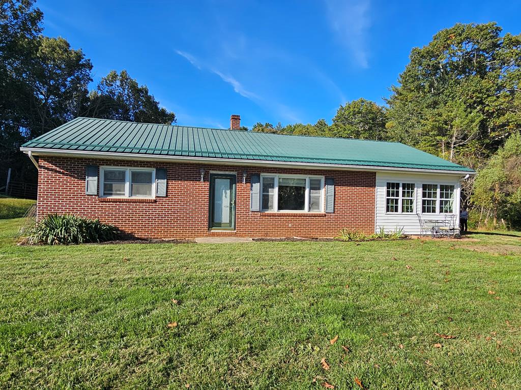 Escape to your own private retreat with this beautiful 9.4-acre secluded mini-farm just outside the charming town of Independence, VA. This brick ranch home features 3 bedrooms and 2 baths, offering an open floor plan with hardwood floors. The updated kitchen boasts stainless steel appliances (which convey), an island, backsplash, and ample cabinet space. Enjoy the spacious living room, a cozy sunroom, and a full walkout basement for additional storage or potential living space. Comfort is assured year-round with a heat pump and a durable metal roof. Outside, you'll find a mix of open and wooded land, a nice spot for enjoying nature or raising animals. The property includes several outbuildings, sheds, run-in shelters for livestock, a chicken coop, and a thriving orchard with apple, peach, and pear trees. A picturesque ridgetop offers nice views, and wildlife frequently passes through the land, adding to the peaceful country setting. All this just minutes from the New River, shopping, and local schools—this place has a nice blend of privacy, convenience, and rural charm. Call Today!