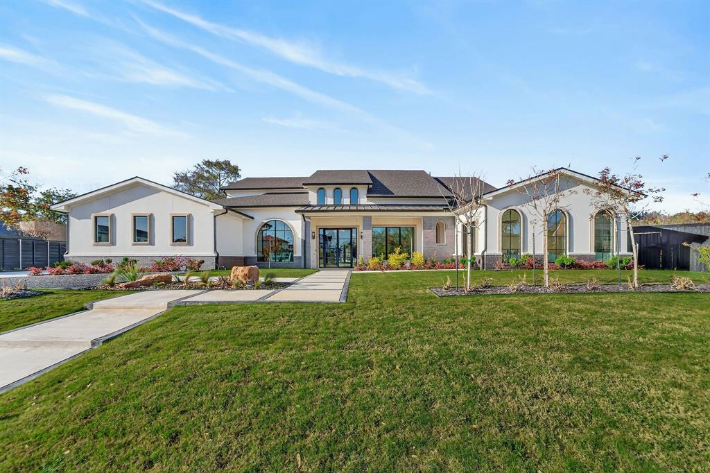 Experience modern elegance in the heart of Preston Hollow. This meticulously designed estate blends timeless style with everyday comfort, featuring four en-suite bedrooms, six baths, two stunning living areas, and dual full kitchens ideal for entertaining. The chef’s kitchen showcases Thermador appliances, a Hestan range, and a custom stone vent hood, complemented by a full secondary kitchen and butler’s pantry. Venetian plaster walls, soaring ceilings, designer lighting, and three statement fireplaces create a refined warmth throughout. Step outside to a resort-style backyard with a sparkling pool, fountains, outdoor kitchen, multiple lounge spaces, and a private sauna. Upstairs, over 1,000 square feet of flexible living space offers endless possibilities—media lounge, fitness studio, or guest retreat. Luxury, comfort, and design converge beautifully in this Preston Hollow masterpiece.