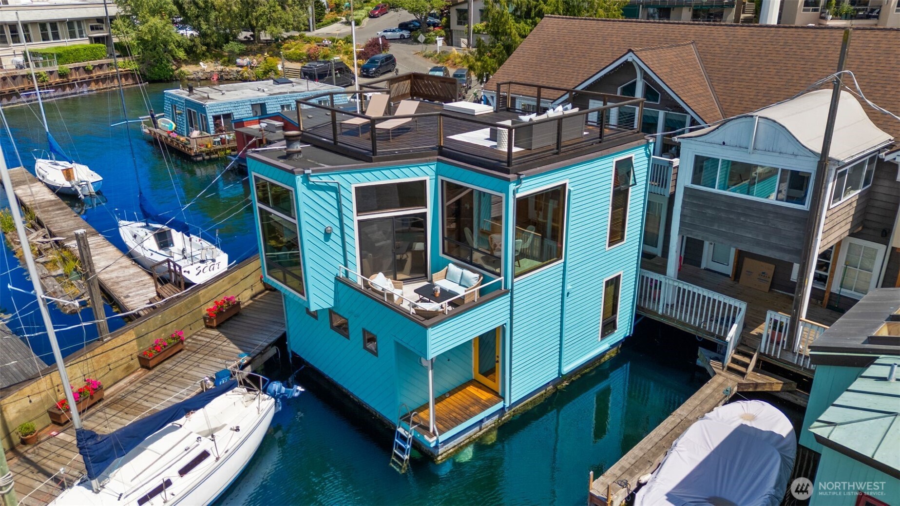 Enjoy million-dollar views, waterfront living, and a vibrant community in this spacious Eastlake floating home! The iconic Rainbow house boasts a fantastic floor plan with three stunning outdoor spaces. The primary suite features a walk-in closet, 3/4 bath, and private waterside deck. The large 2nd bedroom with walk-in closet is steps to 2nd bath. Cooking and entertaining are a breeze in the updated kitchen with breakfast bar and an open layout that connects to the dining and living rooms, and a sweet deck, all with serene water views. Unwind in the cozy den before heading up to the rooftop deck for incredible panoramic city views. First right of refusal for adjacent 24' slip. Experience an amazing lifestyle in this walkable neighborhood!