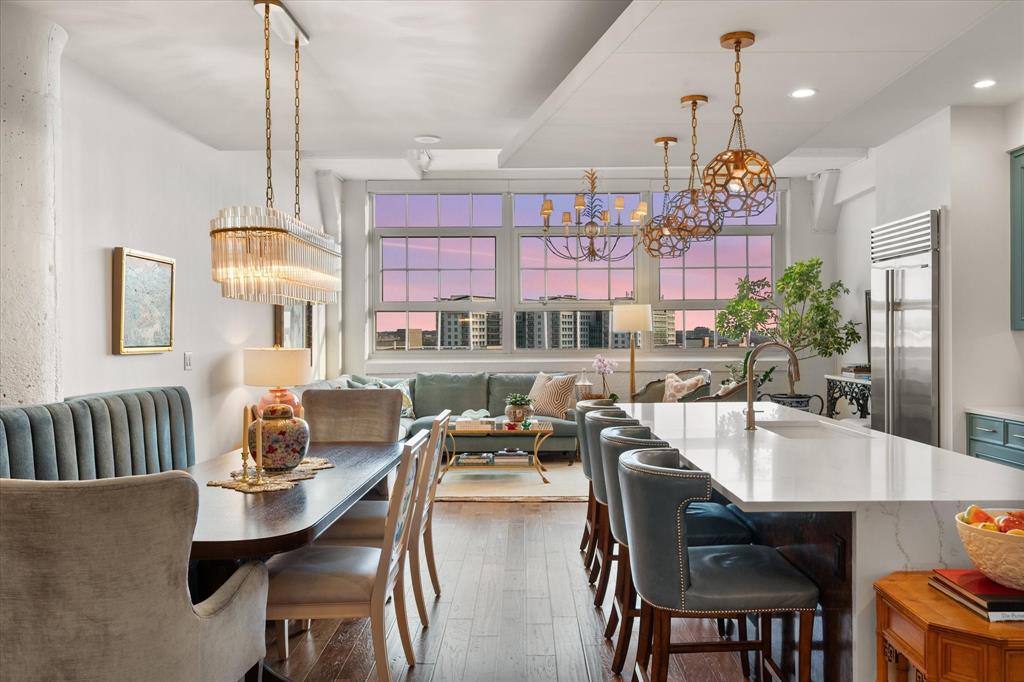Live above it all at Montgomery Plaza, where historic architecture meets refined living in the heart of Fort Worth’s coveted West 7th district.Residence #2638 is a beautifully curated 2-bedroom, 2.1-bath condo that stands apart with elevated finishes, custom details, and breathtaking southern-facing views stretching over Trinity Park toward TCU — delivering spectacular sunset light that pours through the home’s signature oversized windows.Designed for both everyday living and effortless entertaining, the open-concept layout centers around a stunning chef’s kitchen featuring Sub-Zero refrigerator, generous prep space, under cabinet lighting, and seamless flow into the dining and living areas. Just beyond, a striking custom wet bar with rich cabinetry, cabinet and counter lighting, and beverage refrigeration creates a true entertaining moment — equal parts functional and unforgettable.The interiors feel layered and intentional, with curated lighting, tailored wall coverings, and high-end finishes throughout. The guest suite is enhanced by custom built-ins, offering flexibility as a sophisticated home office, library, or private retreat.The spacious primary suite provides a serene escape with a blackout window shade and spa-inspired bath, while the additional powder bath adds convenience for guests.Set within the iconic Montgomery Plaza — a landmark Fort Worth residence — amenities include a resort-style rooftop pool, fitness center, media room, concierge services, and secure parking, all just steps from premier dining, shopping, and entertainment.This is lock-and-leave luxury with architectural character, exceptional light, and a level of finish rarely found — all in one of Fort Worth’s most vibrant urban settings.