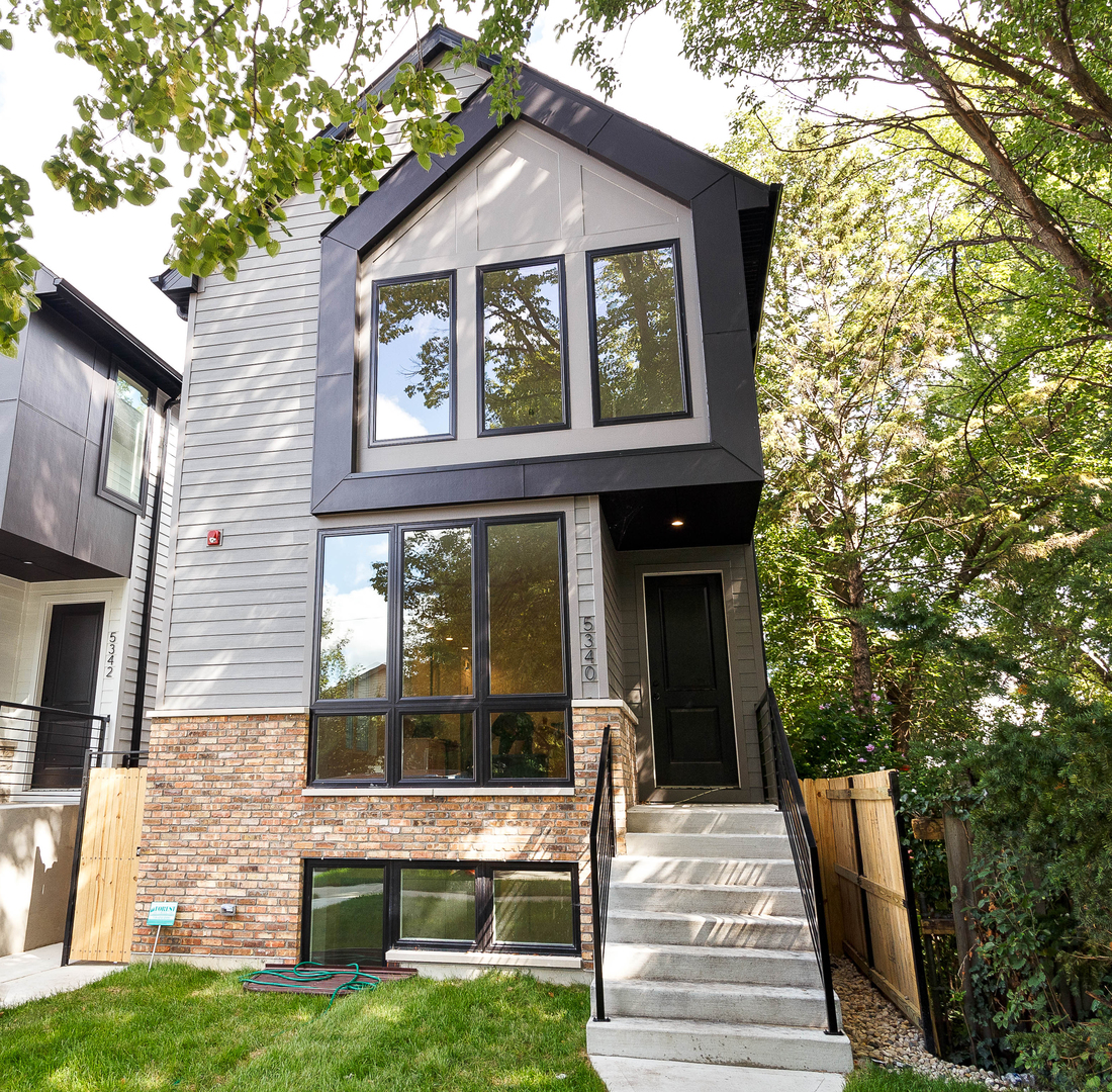 Impeccable 5 bedroom, 4 bath new construction single-family home steps from the Jefferson Park Blue Line and Metra. Spacious floor plan featuring design forward interiors and finish materials. Beautiful oak hardwood flooring, Bosch appliance package, skylights, and more! Enclosed backyard offers plenty of outdoor space and a detached two-car garage. Close to restaurants, entertainment, shopping, public transportation, parks, and other conveniences. Located in top rated Beaubien Elementary district. Exceptional quality home by top developer. Exterior photo is from a similar home with comparable floor plan and finishes.