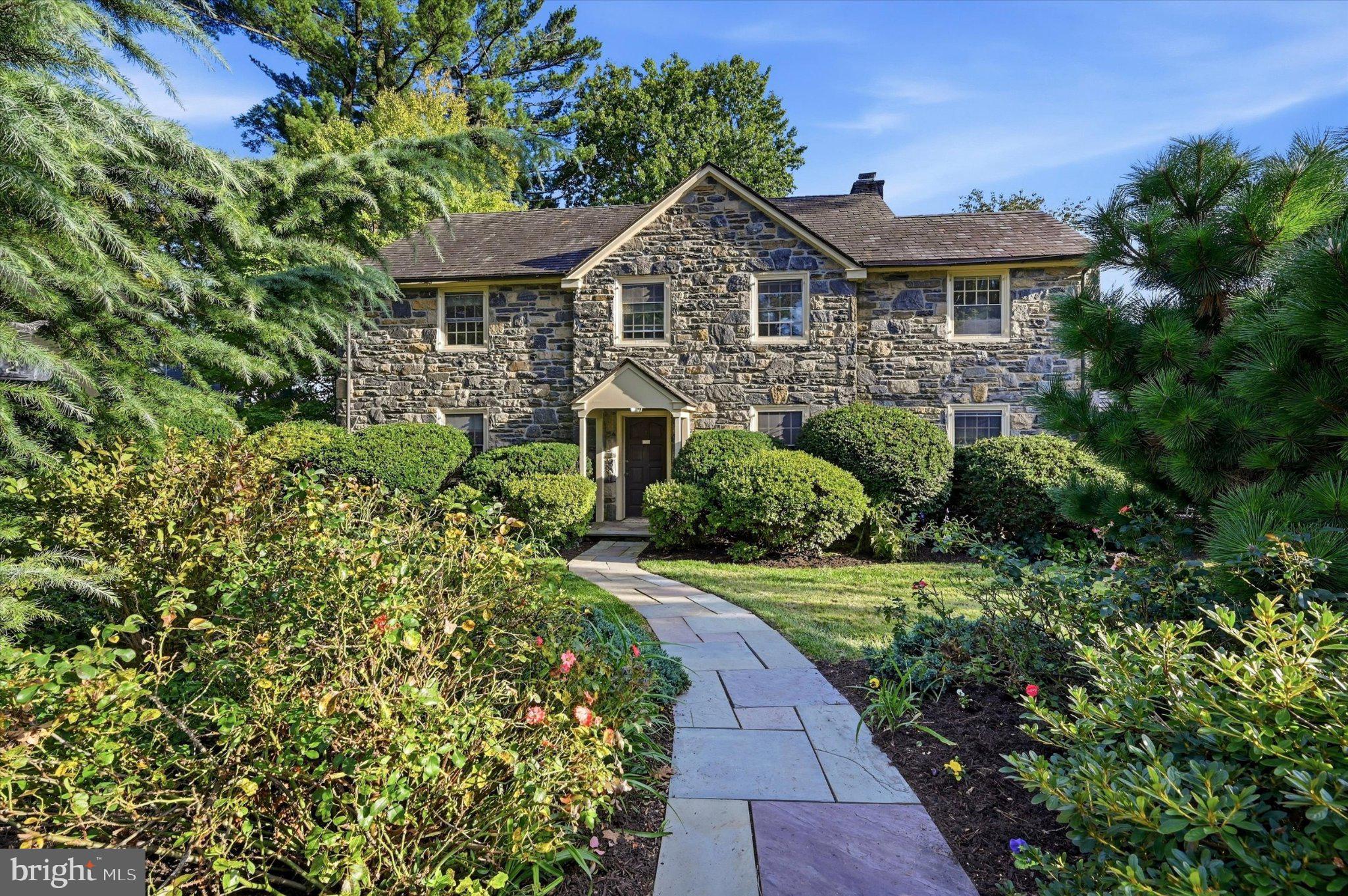 Welcome home to 122 Grasmere Road a classic stone colonial with slate roof that perfectly captures the timeless and storied charm of Bala Cynwyd. From the moment you pull up to the curb of this beautiful corner property the architecture and greenery set a tone of beauty.Step into a home of classic design with architectural details such as hardwood floors, deep window sills, bay window and so much more. The welcoming center hall, features hardwood floors, a convenient coat closet, and a powder room, and sets the tone the moment you walk in. To the right, the expansive living room serves as a true centerpiece, anchored by a wood-burning fireplace and built-ins. French doors open from this space to a private patio, offering a seamless transition to grounds adorned with lush, thoughtful plantings.On the opposite side of the center hall, the large dining room is bathed in natural light from a beautiful bay window.This room is perfect for large holiday dinners or a quiet family meal.This room leads directly into a kitchen with abundant counter space, gas cooking, and a dedicated eat-in kitchen area. An additional outside exit from the kitchen leads to a large patio, perfect for al fresco dining and entertaining. Completing the main level is a versatile office/den/playroom, providing the ideal quiet retreat for remote work or relaxation. This home beautifully balances generous proportions with an intimate, comfortable feel through additional space.Ascend to the second floor, where alarge hallway leads to four comfortable bedrooms. The primary suite is spacious with 3 closets, and an updated primary bathroom with a linen closet. This level also includes a full hall bathroom with bathtub and a convenient linen closet. The other three bedrooms all are spacious with deep closets. For those looking toward the future, a doorway provides easy access to a floored attic equipped with an attic fan—a versatile space perfect for storage or potential transformation into additional living area.The lower level is designed for both productivity and practicality. A flexible bonus room offers the ideal footprint for a dedicated home office or recreation space. This level also houses the laundry facilities and provides a seamless transition to the outdoors via a dedicated exit. Rounding out the basement is interior access to a spacious oversized two-car garage, ensuring convenience regardless of the weather.The magic continues outdoors. The yard is a private oasis, featuring two sprawling patio perfect for al fresco dining and a lush lawn bordered by mature trees. It’s the kind of space that feels worlds away from the hustle and bustle, yet you’re just moments from the vibrant shopping, acclaimed dining, and easy transit options that make the Main Line so desirable.With its blend of historic character and architectural, 122 Grasmere Road is more than just a house—it’s a place to truly plant roots and enjoy the very best of suburban living- with easy access to Center City, King of Prussia, major highways, restaurants, parks, award winning schools, libraries and the Cynwyd Heritage Trail.