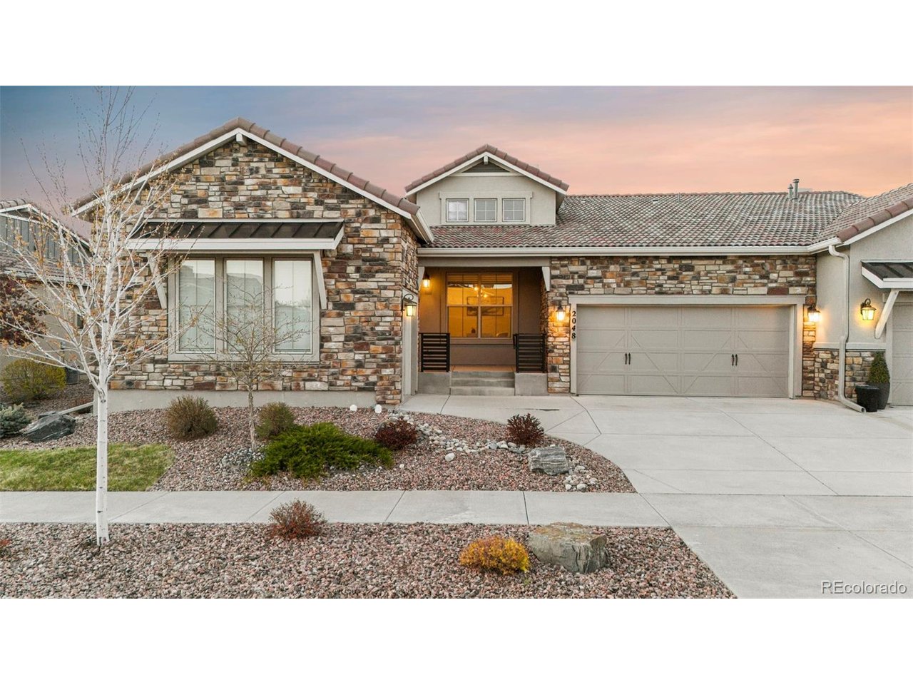 Meticulously maintained, highly upgraded, maintenance free San Isabel paired patio model by Classic Homes located in the highly sought after neighborhood of Flying Horse. This gorgeous ranch style home boasts approximately 3,702 FSF with 4 bedrooms, 4.5 baths plus a main level office, and a 3-car split garage. The open and bright floor plan is designed for comfort with luxurious finishes throughout. Venture into the home and take in the large office with a shiplap accent wall, and main level bedroom with private en-suite bathroom. Continue into the living room/dining room/kitchen area that features a gas fireplace w/stone surround, and a wall of windows. The Chef's kitchen features a large center island with slab granite, a huge breakfast bar, stainless steel appliances, a gas cooktop, and a spacious pantry. The dining area walks out to the enclosed patio and neighborhood greenbelt. Continue into the spacious master suite, which connects to the spa like master bath w/dual sinks, massive shower w/designer tile, separate water closet & huge walk-in closet. Venture downstairs into the lower level that includes an inviting family room w/stone surrounded gas fireplace & a remarkable rec room w/ wet bar complete with a mini fridge. There are 2 additional oversized bedrooms & 2 full baths which complete the lower level. 3 Car divided garage & central AC for your convenience. Grounds are well kept featuring mature landscaping w/all maintenance taken care of by the HOA including the lawn water. Zoned to award winning D-20 schools. This is your chance to live in Flying Horse- near golf, fitness, pools, tennis courts, dining, walking trails, parks & all of the city's best shopping, dining, and healthcare amenities. USAFA, Fox Run park, Northgate/Interquest amenities & the new Sunset Amphitheater are all minutes from your new home, making attending summer concerts a breeze. Schedule your showing today!