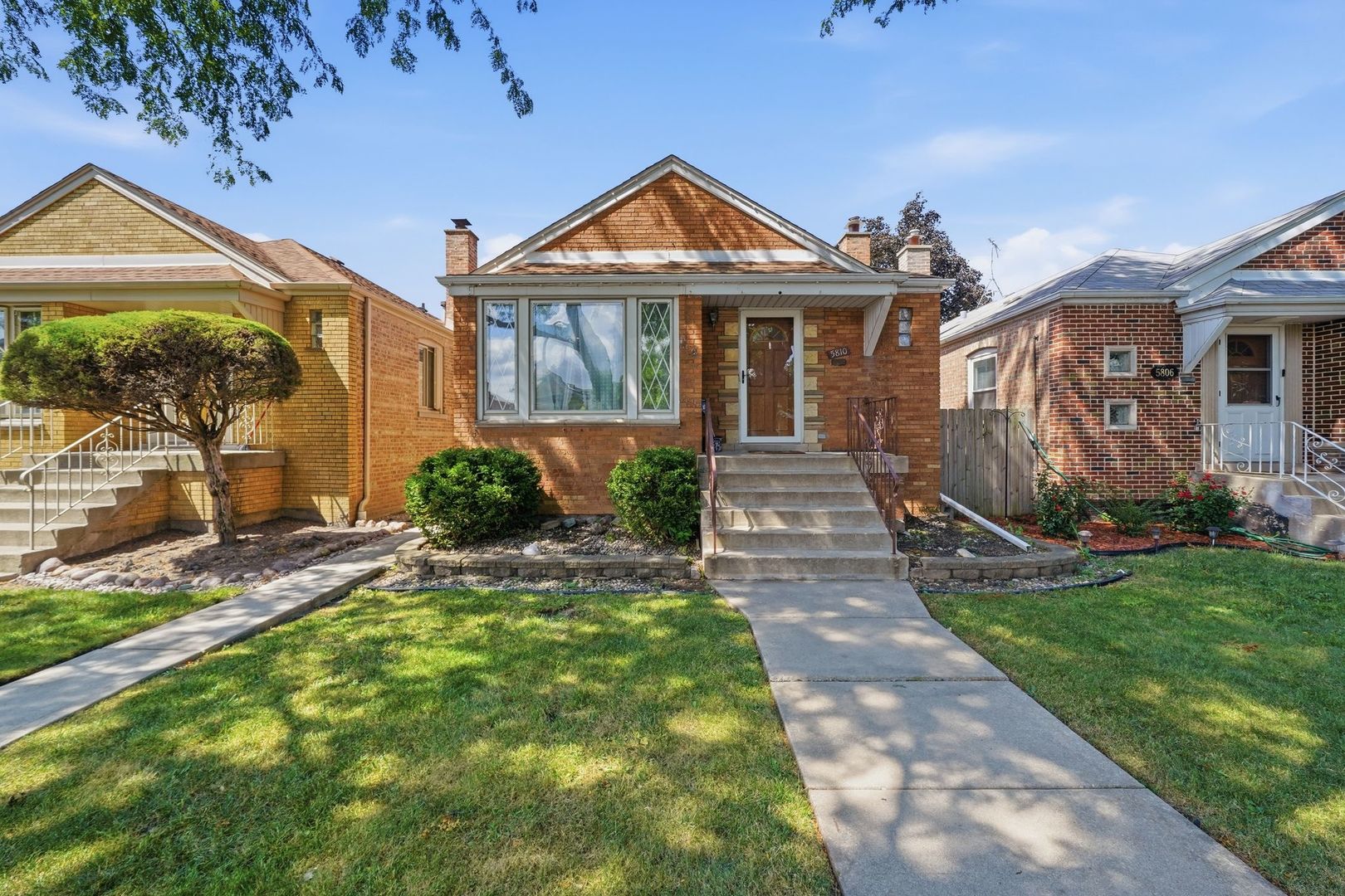 Welcome to this solid brick raised-ranch single-family home in Chicago's Clearing neighborhood, situated on a 30-foot-wide lot. The main level features two bedrooms, hardwood floors, an updated kitchen with stainless steel appliances, and a comfortable eat-in breakfast area for everyday dining. The finished basement offers valuable additional living space with ceramic tile flooring throughout, a spacious family room, a full bathroom, a separate laundry room, and an additional flexible room ideal for a home office, recreation space, workout area, or storage. A two-car garage provides convenient off-street parking and additional storage. Conveniently located near Midway International Airport, restaurants, grocery stores, public transportation, and I-55, offering easy access to downtown Chicago and surrounding areas.