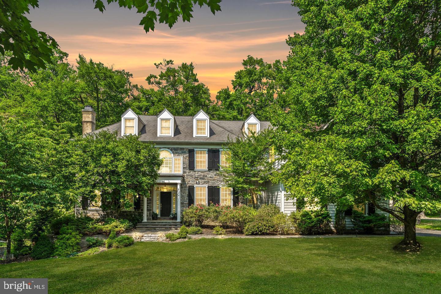 Tucked away in the prestigious community of Villanova, within the highly regarded Radnor Township, this exceptional five bedroom residence embodies refined living at its finest. Set on a beautifully landscaped 1.5 acre lot, the home is surrounded by mature trees and bordered by a tranquil creek, creating a private and picturesque setting that feels worlds away yet remains moments from everything.A long, stately driveway leads to a three car garage and generous parking area, providing both elegance and convenience. The location offers easy access to major thoroughfares, award winning schools, and an array of upscale shopping, dining, and recreational destinations.Upon entering, you are greeted by an atmosphere of timeless sophistication. Gleaming hardwood floors flow throughout the main level, enhancing the light filled spaces. The formal living and dining rooms, each graced with a classic fireplace, exude warmth and charm, perfect for entertaining or relaxing in comfort.The gourmet kitchen is the heart of the home, featuring custom cabinetry, high end appliances, and a sunlit breakfast room that opens to an expansive deck overlooking the peaceful grounds. Adjacent to the kitchen, the inviting family room offers a comfortable space for everyday living. A private first floor office provides an ideal setting for work or quiet study.The fully finished walk out lower level extends the home’s living space, offering a striking ambience that is both modern and inviting. Featuring a large entertainment area and a full service bar, it is the perfect setting for hosting gatherings or enjoying relaxed evenings with family and friends.Upstairs, the second level offers five spacious bedrooms designed for comfort and privacy. The primary suite serves as a luxurious retreat, complete with generous closets and a beautifully appointed bathroom. Each additional bedroom offers ample storage and access to well designed baths.The finished third floor adds valuable flexibility, currently configured as a gym and laundry area but easily adaptable as a media room, playroom, or additional living space.Blending classic architecture with modern amenities, this Villanova residence delivers a lifestyle of sophistication, comfort, and tranquility, all within one of Radnor’s most sought after neighborhoods.