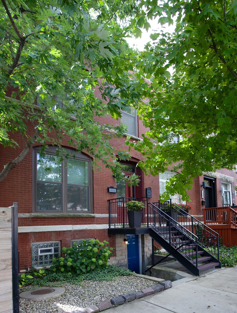 Fully Renovated 1880's Row House. Prime Location West Town adjacent. Just 2 blocks from the Green Line train and a few blocks from the new United Center 1901 Project.   Meticulous maintenance by same owners for 15 years includes flood prevention system, heated primary bath floors, newer roof, appliances, siding, tuckpointing, front entrance door and windows. The fully independent lower level 1-bedroom, 1-bath apartment style layout (new 2021) with its own private entrance, and optional interior connection offers flexible living or strong rental income. Currently used  as a successful short-term rental (generating over $30,000 yearly).     Rarely found in the city, the expansive 40x100 ft side yard offers exceptional privacy, framed by mature trees, flowering perennials, and professional landscaping.    This unique opportunity  seamlessly combines thoughtfully designed living spaces, versatility, and rare urban outdoor amenities. If you are an animal lover the Owner's current foster is also looking for a home. Adoption fees will be credited at closing :)  Lower level can be viewed  on 2nd showing request.