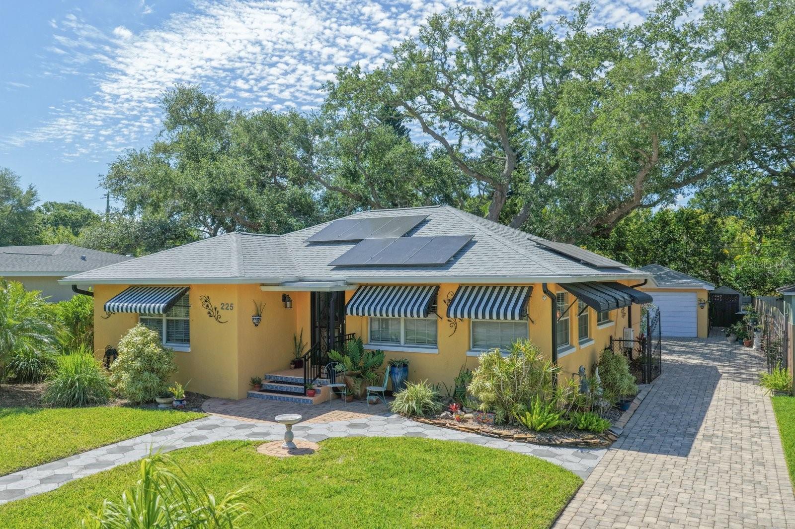 Under contract-accepting backup offers. Classic Dunedin Bungalow...Timeless Charm in the Heart of Downtown. Perfectly positioned in one of Dunedin’s most sought-after locations and situated in a non-flood zone, this quintessential bungalow captures the true essence of coastal living. A rare and valuable offering, the property is also zoned for an ADU/in-law suite; presenting exceptional flexibility and future potential. Rich in character and authenticity, the home showcases original hardwood floors, graceful archways, and vintage-inspired details that seamlessly blend with thoughtful updates. Two generously sized bedrooms are complemented by an expansive enclosed, air-conditioned bonus room, ideal as a secondary living space, guest retreat or private office. Set on a lush, park-like .21-acre lot, the outdoor setting offers both privacy and possibility, complete with an oversized detached garage and a fully fenced backyard accessed through a classic wrought-iron double gate. The kitchen is both refined and functional, featuring custom KraftMaid oak cabinetry with pull-out drawers, granite countertops, mosaic tile backsplash, a substantial island, and a charming eat-in area, all paired with a stainless Frigidaire Gallery appliance package. Natural gas is already connected and the home is enhanced by clean, modern finishes including the absence of popcorn ceilings and the convenience of an interior laundry room. Recent improvements include a newer roof (2025), providing added peace of mind. A brick-paver driveway and walkway elevate curb appeal, while the location delivers an unmatched lifestyle, just a short stroll to the waterfront, vibrant Main Street, local boutiques, breweries, dining, and the Pinellas Bike Trail. Enjoy effortless access to everything via golf cart, from farmers markets to art festivals and sunset dinners. This is more than a home, it’s a lifestyle. This is Dunedin, defined.