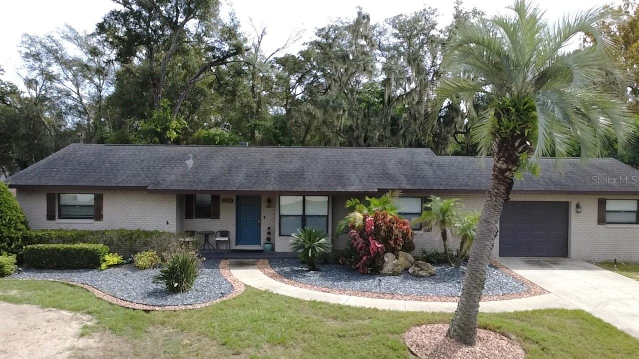 Your own private oasis in a quiet neighborhood with no HOA or CDD.  Bring all your toys, plenty of parking. New HVAC 2025, new septic drainfield August 2026, new windows 2017 and in sunroom in 2025.  Beautiful updates throughout with fresh neutral paint.  Storage/workshop in garage.  All appliances including washer and dryer, both refrigerators, microwave and two wall mounted televisions are included!   Woodburning fireplace has never been used by current owner - it has been capped since purchase.  This house appraised in June for $392,000.