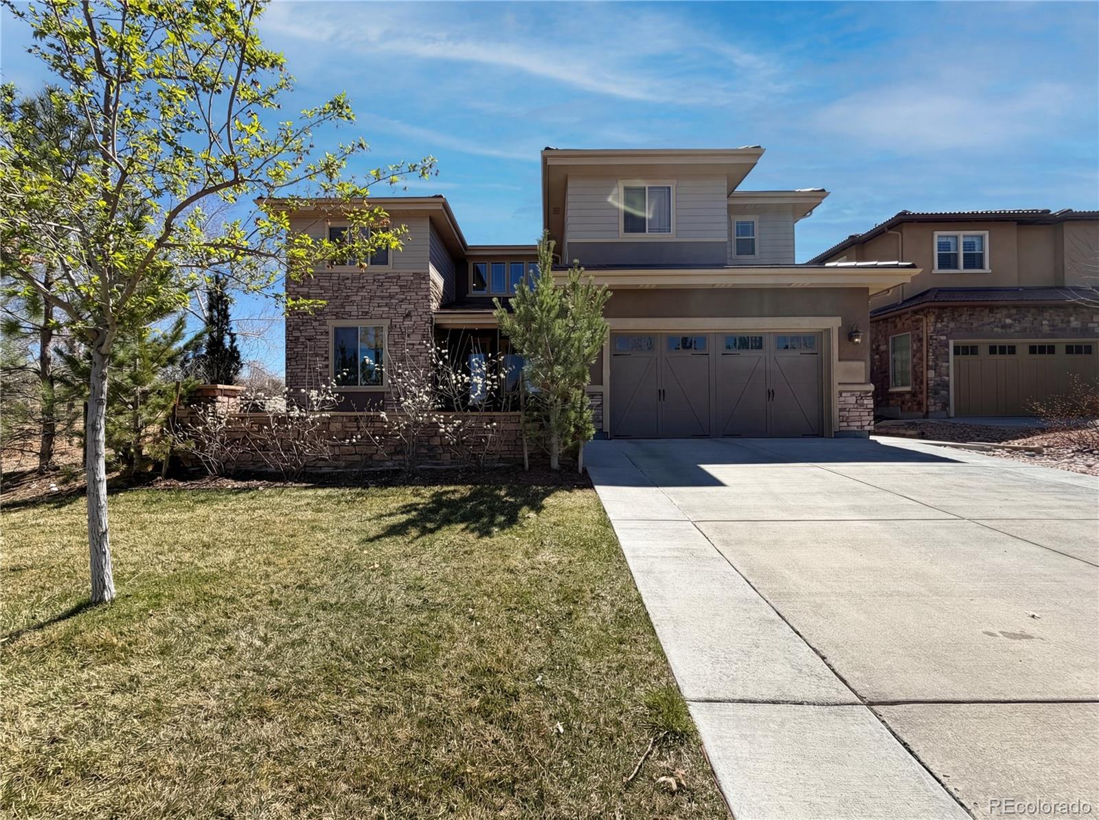 Welcome to this thoughtfully designed two-story residence located in Highlands Ranch. Built in 2019 and situated on a corner lot within an established community, this home offers a functional layout with five bedrooms and five bathrooms, providing flexibility for a variety of living arrangements.The main level features an open floorplan with wood flooring, an eat-in kitchen complete with an island, and seamless flow into the dining and living areas—well suited for everyday living or gatherings. A main-floor bedroom with a three-quarter bathroom adds convenience and versatility. Interior highlights include built-in features, an open kitchen design, and generous storage throughout.Upstairs, three bedrooms are complemented by three bathrooms, including a primary suite with a walk-in closet and a well-appointed private bathroom. The finished basement expands the living space with an additional bedroom, bathroom, and family room, as well as unfinished area for storage or future use.Outdoor living is enhanced by a private yard and patio featuring a large outdoor fireplace, creating an inviting space for year-round use. Residents have access to community amenities including a clubhouse, fitness center, pool, tennis courts, trails, parks, and other recreational features through the Highlands Ranch Community Association. The property is located within the Douglas RE-1 School District and is conveniently positioned near local services, recreation, and major roadways.