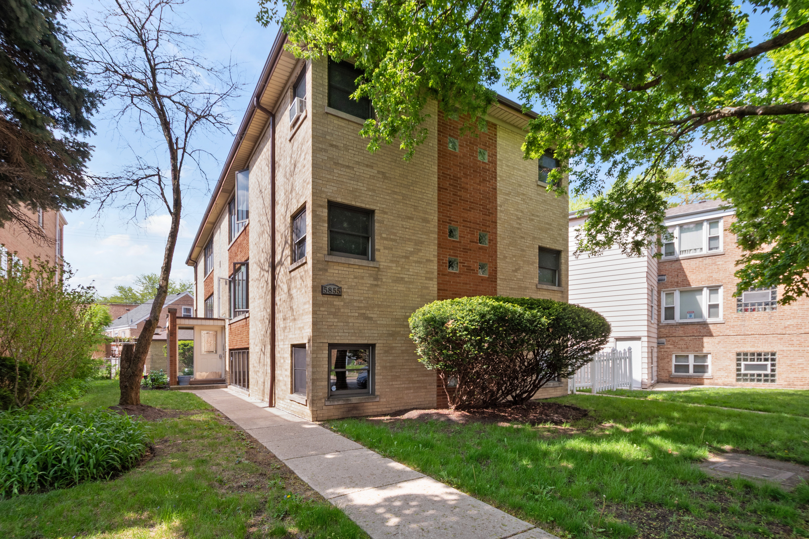 This bright and inviting 1-bedroom garden condo offers a smart layout with a comfortable living area, large windows, and stylish wood-style flooring. The galley kitchen features white cabinetry, sleek black quartz countertops, and stainless-steel appliances, including a gas range and full-size refrigerator-perfect for everyday cooking and entertaining. The bedroom fits a queen-sized bed and receives great natural light from two windows. A clean, updated bathroom with a pedestal sink and tub/shower combo adds to the unit's functionality. Shared laundry is conveniently located just outside the door. Enjoy access to a private-feeling outdoor space with a raised deck, string lights, and garden beds-ideal for relaxing or hosting. Situated in a well-kept building with easy access to the train and expressway, this home is a great fit for first-time buyers, downsizers, or investors looking for a low-maintenance option in a convenient location.