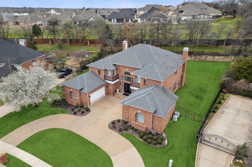 Welcome to this exquisite home in Southlake Woods, where meticulous design and loving maintenance come together in perfect harmony. This stunning 5-bedroom, 4.5-bathroom floor plan seamlessly blends style and functionality, offering a variety of spacious living areas, including an office, theater room, formal living room, family room, and two dining areas. The oversized bedrooms provide ample space, with one bedroom on the main floor featuring an ensuite bathroom. Inside, the grand foyer, complete with a double staircase, plus crown molding and plantation shutters throughout, creates an inviting atmosphere.

The gourmet kitchen opens to a bright breakfast area and living room, leading to a media room, making this home ideal for both entertaining and everyday living. The formal living and dining rooms, along with an executive study, add even more to the home's appeal. Upstairs, the large primary suite offers a serene retreat, featuring a spacious bathroom, oversized walk-in closet, and mirrored dressing area. A private balcony overlooks the expansive backyard, offering a perfect spot to unwind.

With abundant storage throughout, including large closets and built-in cabinetry, this move-in-ready home is freshly painted and waiting for you. Located in the acclaimed Carroll ISD and just minutes from shopping, dining, and DFW International Airport, this property is a true gem!