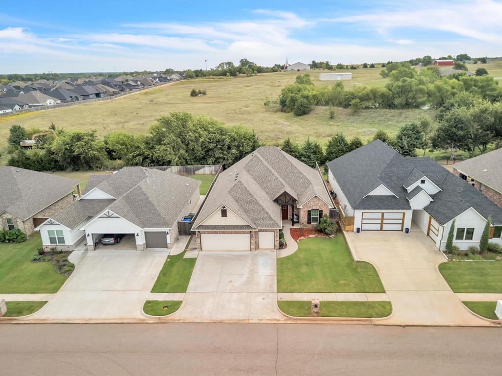 Welcome to this stunning 3 bedroom, 2.5 bath home with a versatile pocket office and over 2,000 sq. ft. of thoughtful design. The open concept layout showcases rich hardwood floors, a beautiful kitchen with leathered granite island, granite counters, stainless appliances, gas stove, built-in spice racks, pull-out trash bin, and a butler’s pantry with extra storage. The mud room offers abundant cabinetry, while plantation shutters throughout add timeless style.
The luxurious master suite features heated floors, a soaking tub, walk-in shower, double vanity, and a dream closet with built-in dressers that connects directly to the laundry room. With a spacious hall bath offering extra storage and a walk-in shower, plus beautiful details throughout, this home combines comfort, function, and style at every turn. 
Additional highlights include a central vacuum system, built-in speakers in the living room, a sprinkler system, and a walk-in storm shelter hidden in a spare bedroom closet. The roof is a heavy composition roof, installed in 2021, offering both durability and peace of mind.
Step outside to the expansive covered patio with cathedral ceiling and a beautiful view, complete with an outdoor kitchen featuring a built-in gas grill and flat top grill—perfect for entertaining. Set in the coveted Vintage Creek community, you’ll have access to a pool, clubhouse, fishing ponds, and tranquil walking paths.