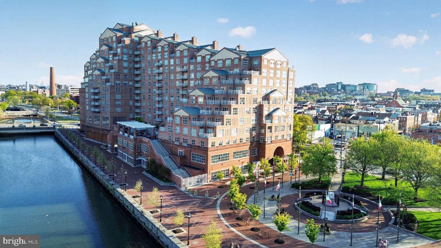 High floor Scarlett Place 2BR/BA condo, offers luxury waterfront living in the heart of downtown Baltimore, ideally situated between Little Italy and Harbor East with scenic harbor views and direct access to several family friendly parks, promenades, dining, shopping, and entertainment, Pier 6 open air concert pavilion, National Aquarium. This bright east-facing 2BR/2BA condo filled with an abundance of natural light, spacious at 1,457 sq ft features an open-plan layout with bedrooms positioned on opposite sides for added privacy, a private balcony, Italian marble entryway, updated seamless LVP flooring kitchen/dining/living area, modern kitchen appliances, adjoining living and dining areas, generous storage and one secure garage parking space.Residents enjoy exceptional communal amenities including a manned front desk, secure building access, wheelchair accessible, full service elevator access, resident lounge, 24/7 gym and heated indoor pool, harbor-view water side outdoor secure terrace with BBQ and lounge areas, and additional storage, secure garage.Recent condo updates include a 50 gallon fiber glass hot water heater, a large in-unit stacked washer/dryer, dishwasher and microwave. Seamless LVP flooring throughout kitchen/dining /living areas. Annually inspected and maintained CAC unit.The condo offers impressive views of Baltimore’s landmarks including the Phoenix Shot Tower, Johns Hopkins Hospital dome, and Patterson Park Pagoda to admire.