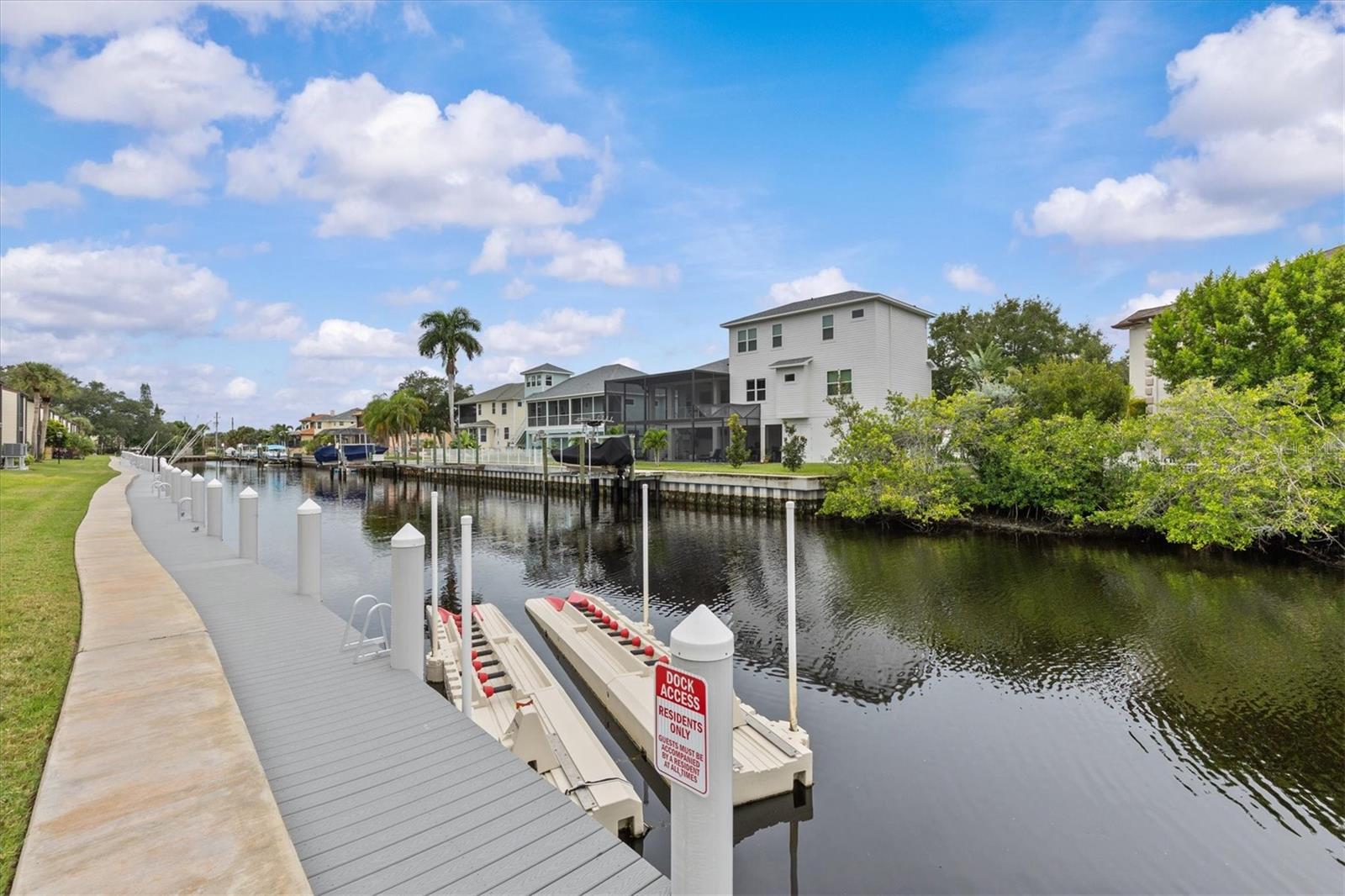 FREE BOAT DOCKING INCLUDED! GULF-ACCESS BOATING COMMUNITY! Bring your boat and enjoy the incredible convenience of having your boat right outside your back door at no additional cost. Boat docks are included in the monthly HOA fee and are available on a first-come, first-served basis. This beautifully renovated first-floor 2-bedroom, 2-bathroom waterfront residence offers the perfect combination of coastal Florida living, modern updates, and resort-style amenities.Everything has been completely renovated from floor to ceiling, creating a truly move-in-ready home. The brand-new kitchen features beautiful cabinetry with soft-close doors and drawers, elegant quartz countertops, and new appliances. Additional updates include luxury vinyl tile flooring throughout, a new electrical panel, new A/C, and so much more. The home also offers generous closet and storage space, along with a washer and dryer conveniently located inside the unit.Step outside and enjoy spectacular canal-front living, where you can relax and watch dolphins and manatees play right from your community. With Gulf access just minutes away, this is a boater's dream location. The community offers an impressive array of amenities, including a heated waterfront pool, clubhouse, waterfront dock and boardwalk, kayak and paddleboard launch, gazebo picnic area, covered bike storage, and storage racks for kayaks and canoes.The HOA fee includes an exceptional list of services and expenses, including internet, cable TV, water, sewer, trash, common-area taxes, master insurance including flood insurance, and grounds and exterior maintenance. Enjoy worry-free living while taking advantage of the beautiful waterfront surroundings.Location is equally impressive. Walk or bike to downtown Tarpon Springs to enjoy local restaurants, shops, and the charm of this historic community. You are also close to Sunset Beach, Fred Howard Park, the famous Tarpon Springs Sponge Docks, golf courses, hospitals, and the approximately 53-mile Pinellas Trail, perfect for walking, running, and cycling.This is a rare opportunity to own a completely renovated waterfront home in a desirable Gulf-access boating community with FREE BOAT DOCKING, incredible amenities, and an unbeatable Tarpon Springs location. Come experience the Florida lifestyle you've been waiting for!